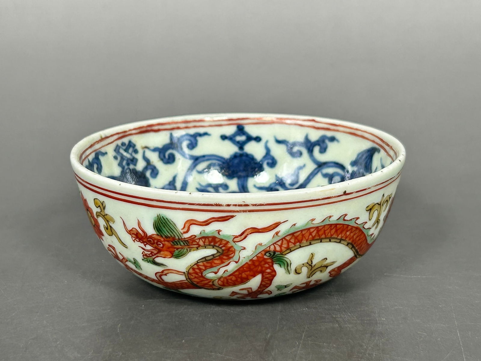 A Chinese Small Underglaze-Blue Decorated Wucai 'Dragon' Bowl, Ming Dynasty: A Jiajing mark to the underside. 1.1/2 in. high, 3.3/4 in. wide.