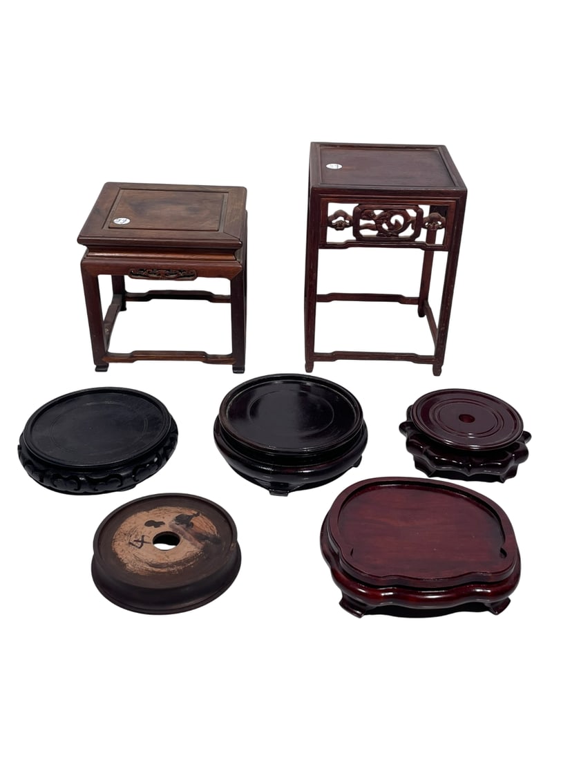 A Group of Seven Chinese Wood Stands: Comprising two square-shaped stands and five circular stands. The largest measures 10 in. high, 7 in. square.