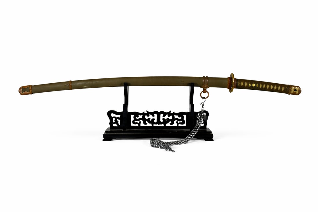 A Japanese Samurai Sword Katana, Nishibe Munenaga Mark: Nishibe Munenaga mark to one side of the tang, Blade with midare hamon and masame hada, fitted with a copper habaki and a nakago with a single mekugi-ana. The tsuka is wrapped over ray skin and mounte