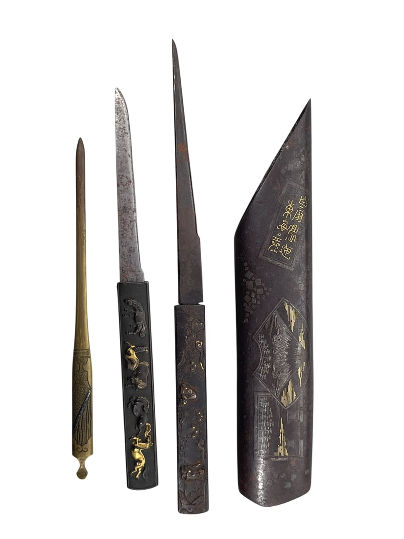 A Group of Four Japanese Metal Objects: Comprising a tip case, 7 in. high, 1.3/8 in. wide; two kozuka for samurai sword, with the longer one measures 8.1/2 in. long; and a kogai hairdressing tool, 6.1/8 in. long.