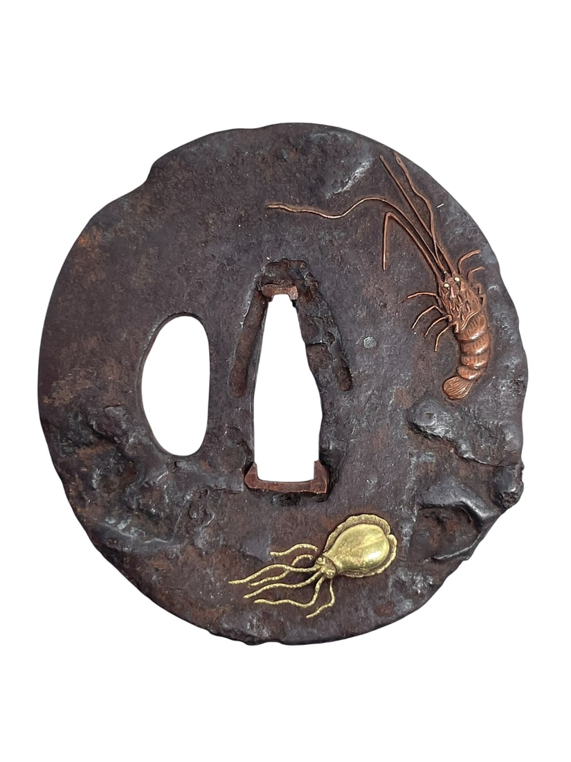 A Japanese Samurai Sword Guard, Tsuba: With a ocean creatures decoration; 2.7/8 in. long, 2.5/8 in. wide.