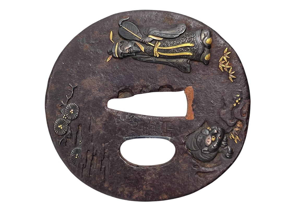 A Japanese Samurai Sword Guard, Tsuba, Motohiro Mark: Maker's mark Motohiro, probably Shokatei Motohiro to one side of the tsuba; 2.3/4 in. long, 2.5/8 in. wide.