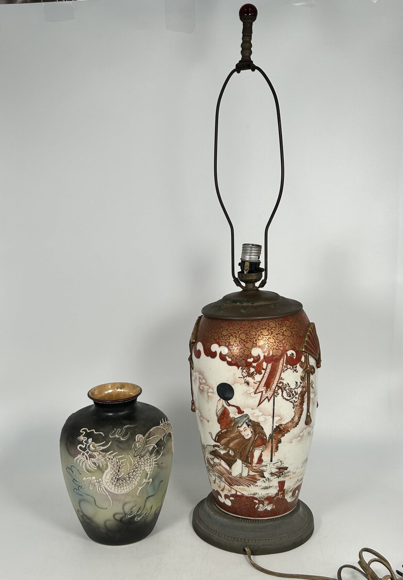 Two Japanese Vases: Comprising a satsuma 'figural' vase, mounted as a lamp, the vase measures 11.1/2 in. high, 7 in. wide, 29 in. high, 7 in. wide overall; and a vintage hand painted dragon motif porcelain vase, 8.1/4 in