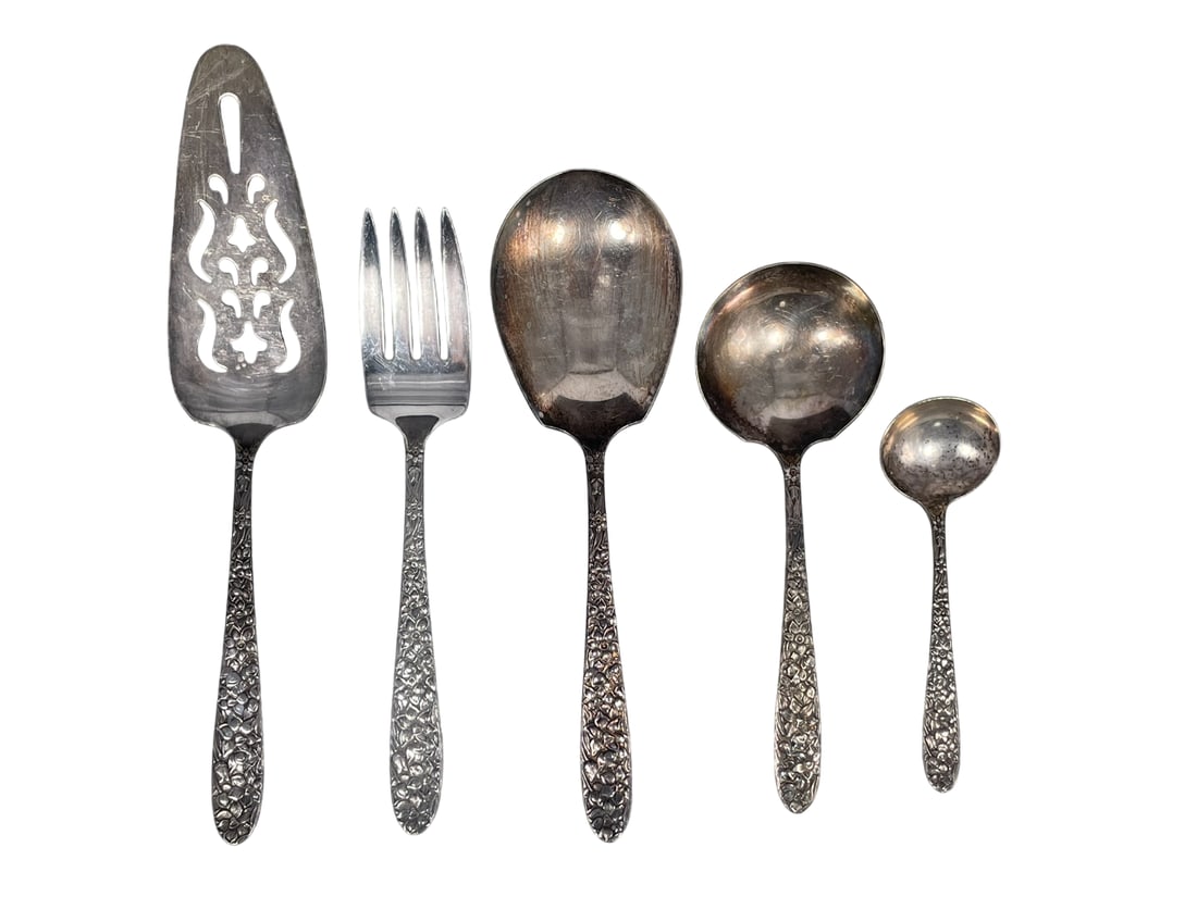 A Group of Five National Silver Company Narcissus Silverplate Flatware: Comprising a pierced pie/pastry server, 9.1/2 in. long; a meat fork, 8 in. long, 1.1/2 in. wide; a Casserole Berry Spoon, 8.5/8 in. long, a Gravy Ladle, 6.1/2 in. long; and a spoon, 5 in. long.