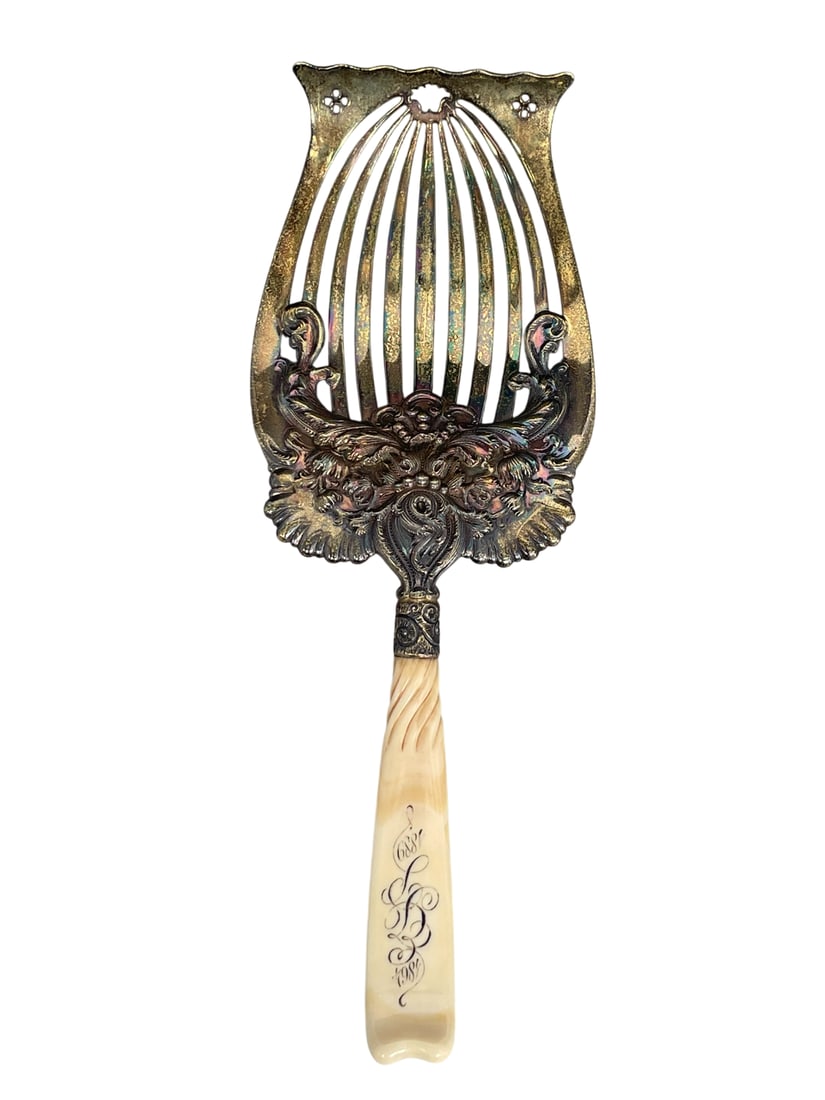 An Antique Sterling Silver Asparagus Server, Late 19th Century: Marked lion with W, numbered 2888, 10.5/8 in. long, 3.7/8 in. wide.