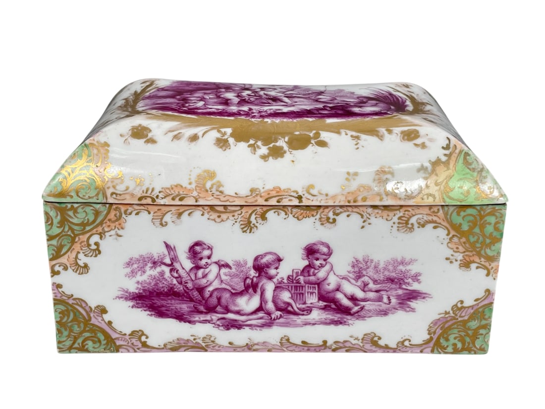 A Meissen-Style Hand-Painted Gilt-Decorated Porcelain Trinket Box, 19th Century: 4 in. high, 7.1/4 in. wide, 5 in. deep.