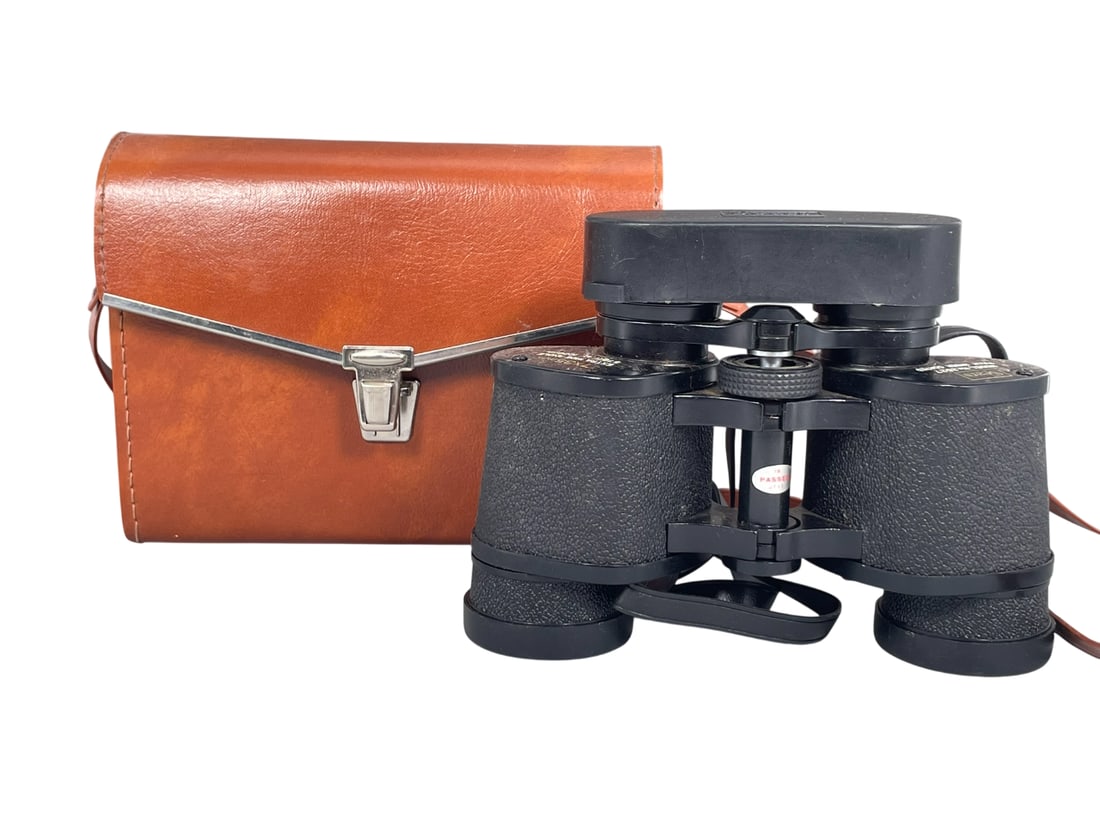 A Sears Model No.2527 Binoculars: Featuring 7x35 lenses with a wide angle field of view. 5.1/4 in. high, 6.3/4 in. wide. With a simulated leather case.