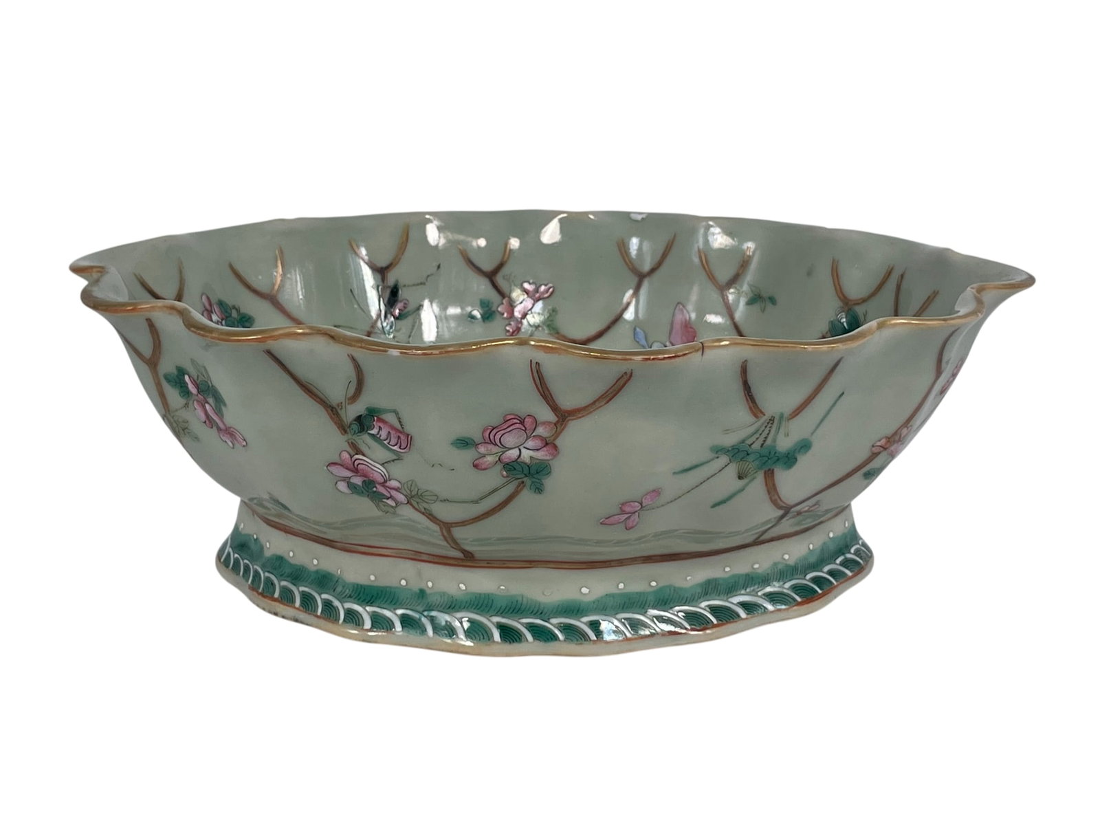 A Chinese Famille Rose Celadon-Glazed 'Butterfly and Flower' Oval Bowl, Qing Dynasty: 3.1/2 in. high, 10.1/2 in. wide.