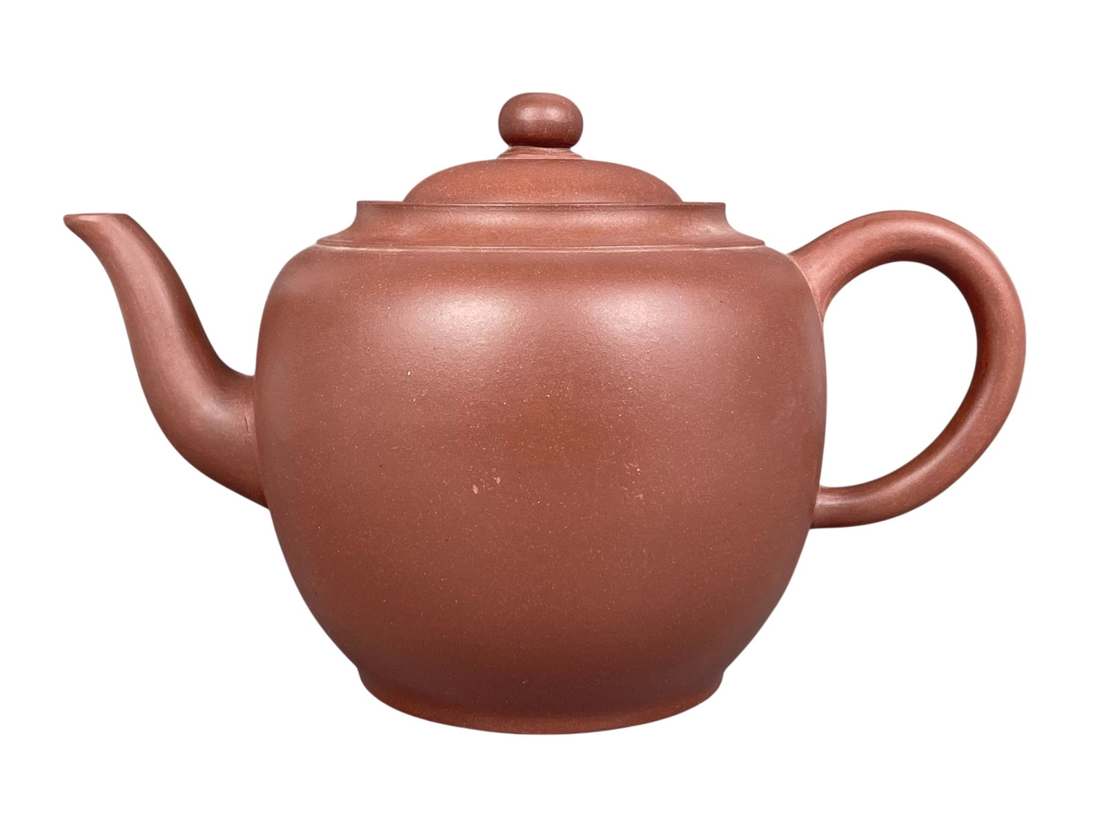A Chinese Yixing Pottery Teapot and Cover: 5.1/4 in. high, 8.1/2 in. wide.