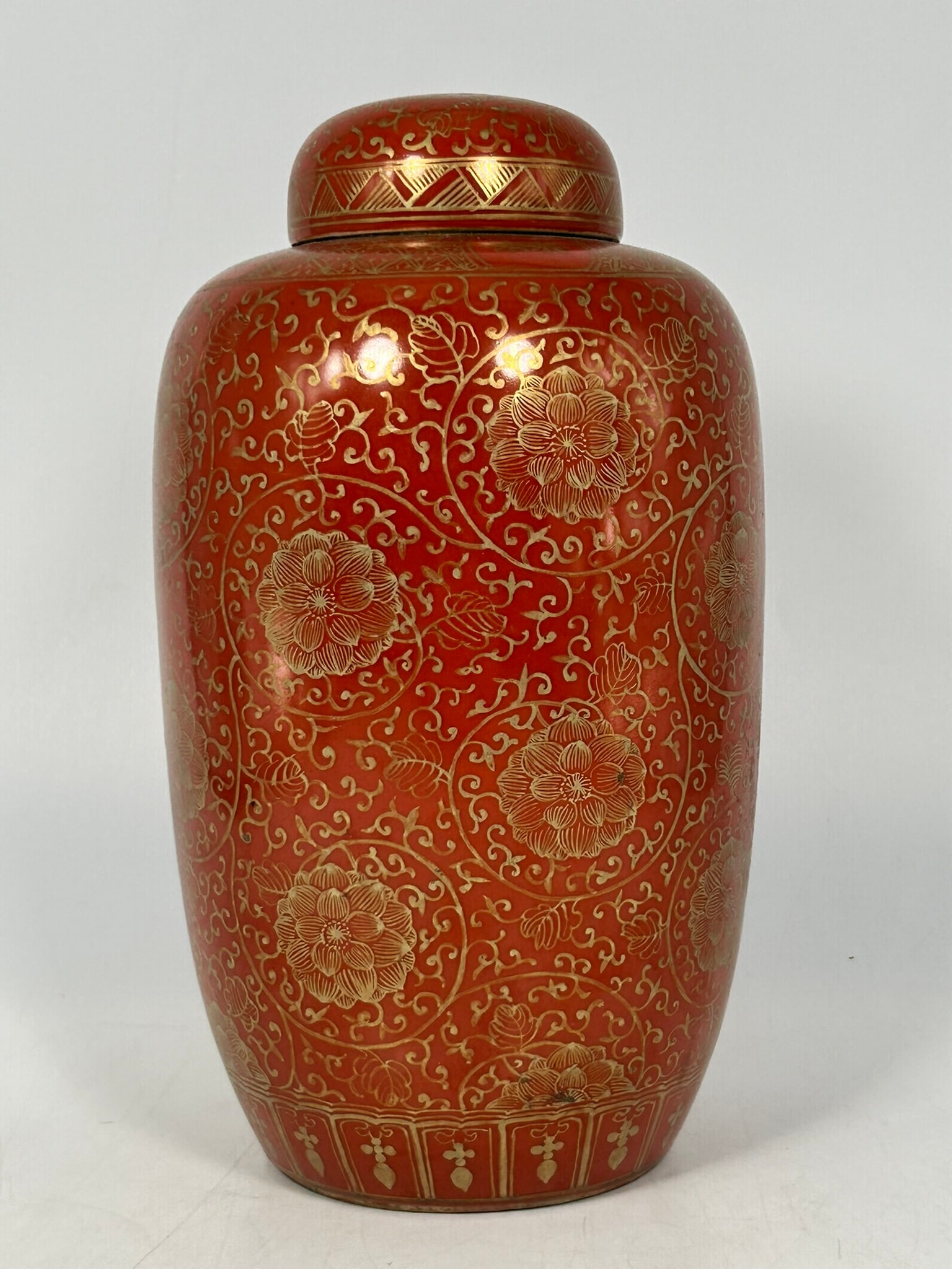 A Chinese Coral-Red-Glazed Gilt Decorated Vase and Cover: 9.5/8 in. high, 5.1/4 in. wide.