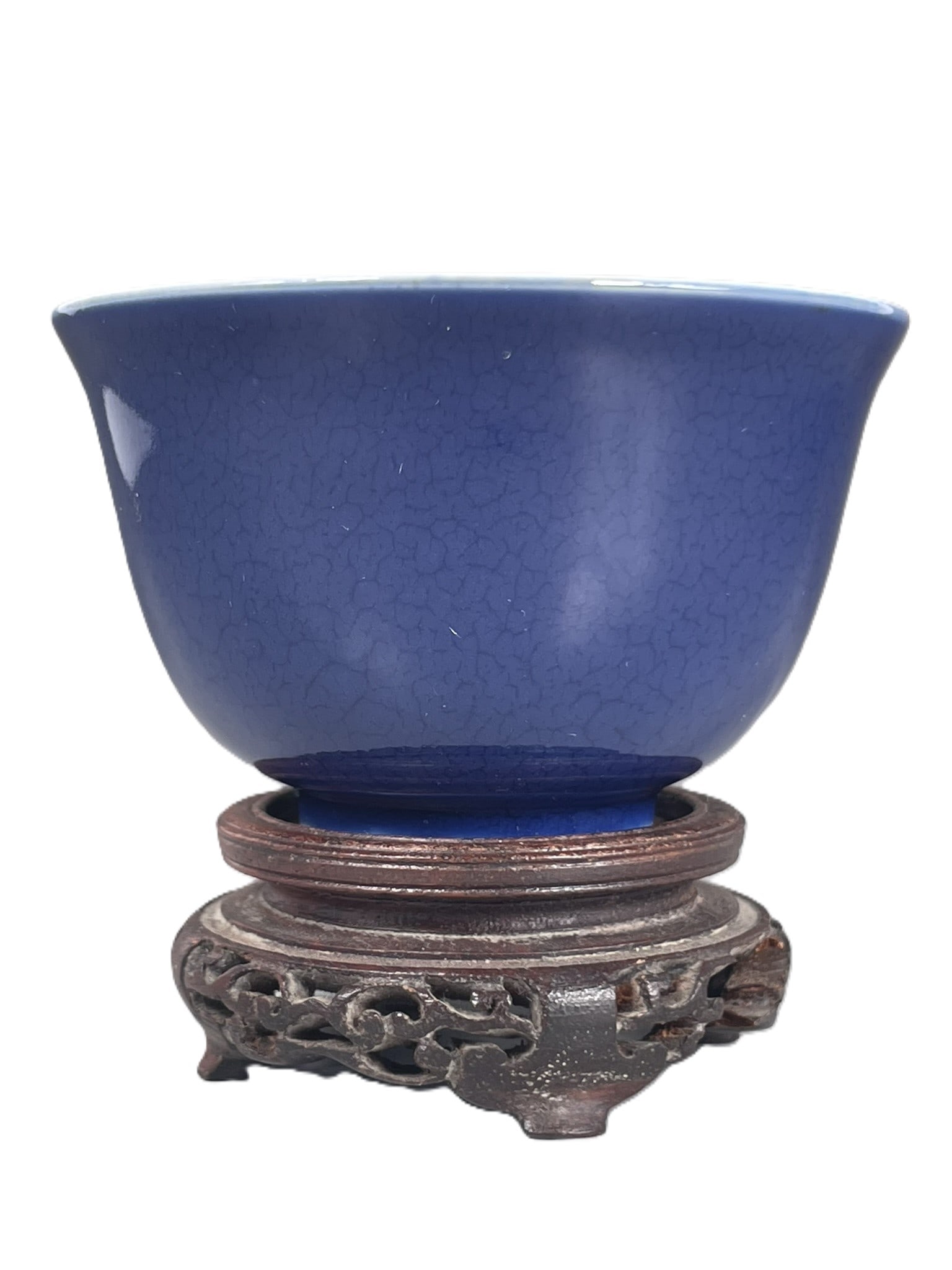 A Chinese Powder-Blue-Glazed Cup: With a wood stand. A apocryphal Xuande mark to the base. The cup measures 1.7/8 in. high, 3 in. diam.