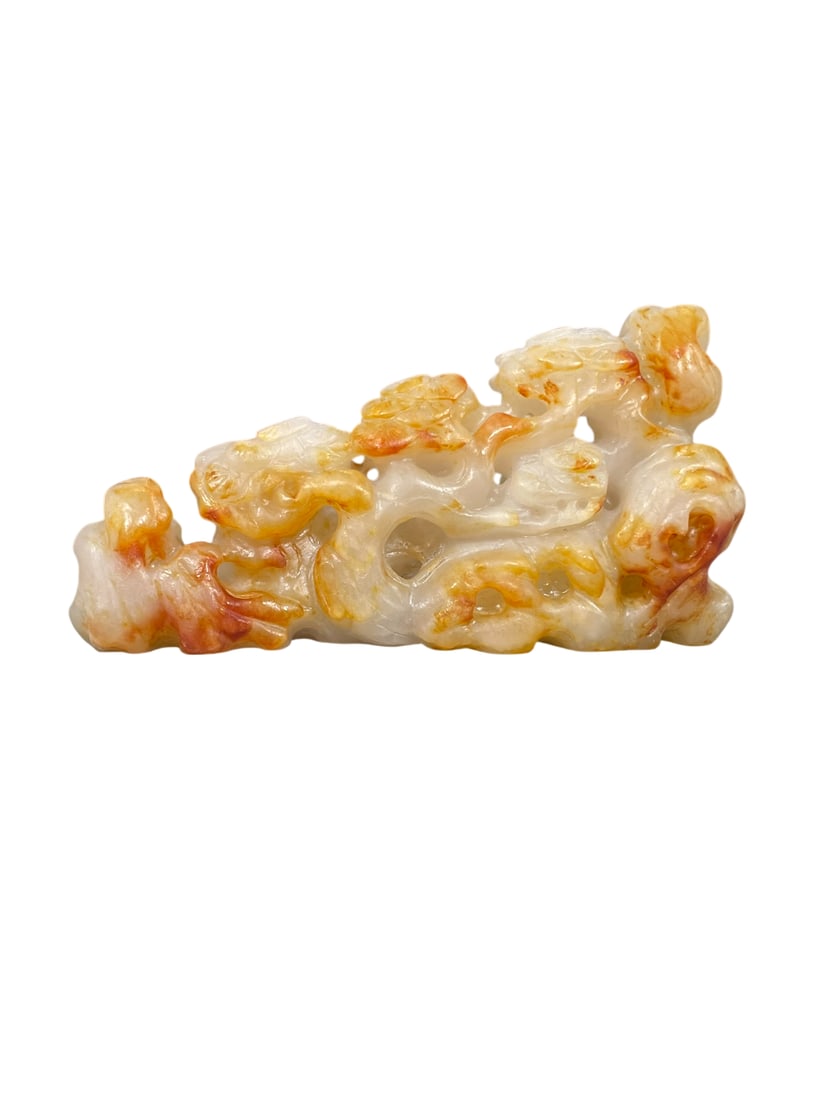 A Chinese Carved White and Russet Jade Brush Rest: 2.3/4 in. high, 5 in. wide.