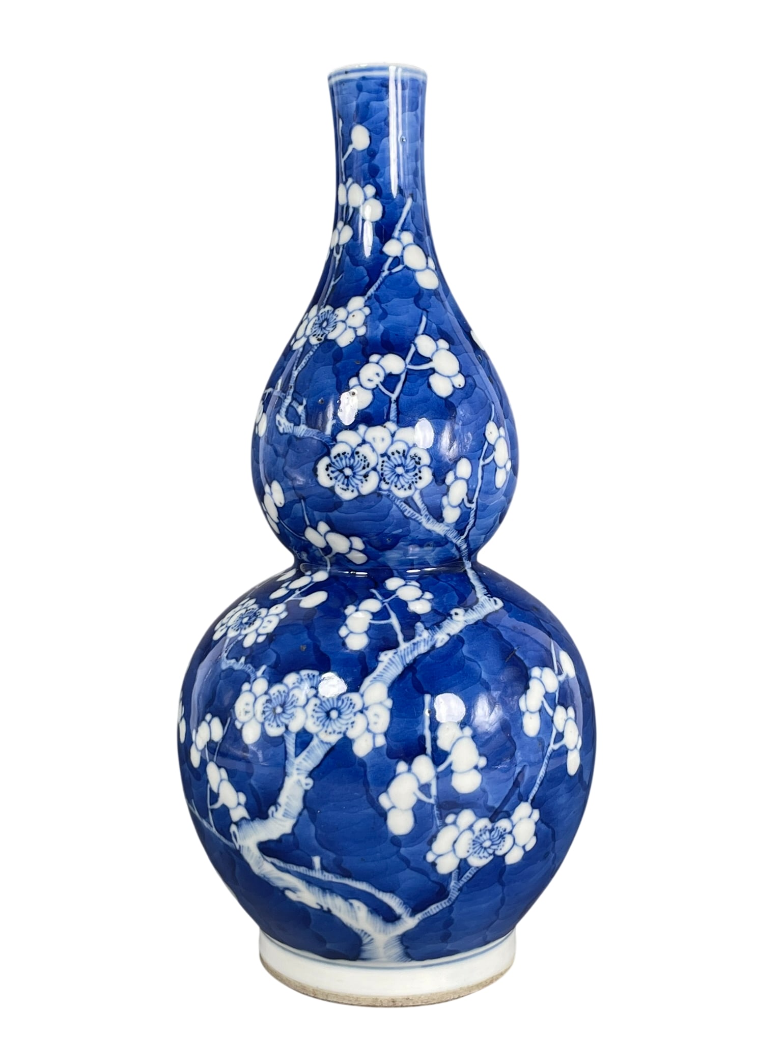 A Chinese Blue and White 'Blossoming Plum Branches' Double Gourd Porcelain Vase: 10 in. high, 4.1/2 in. wide.