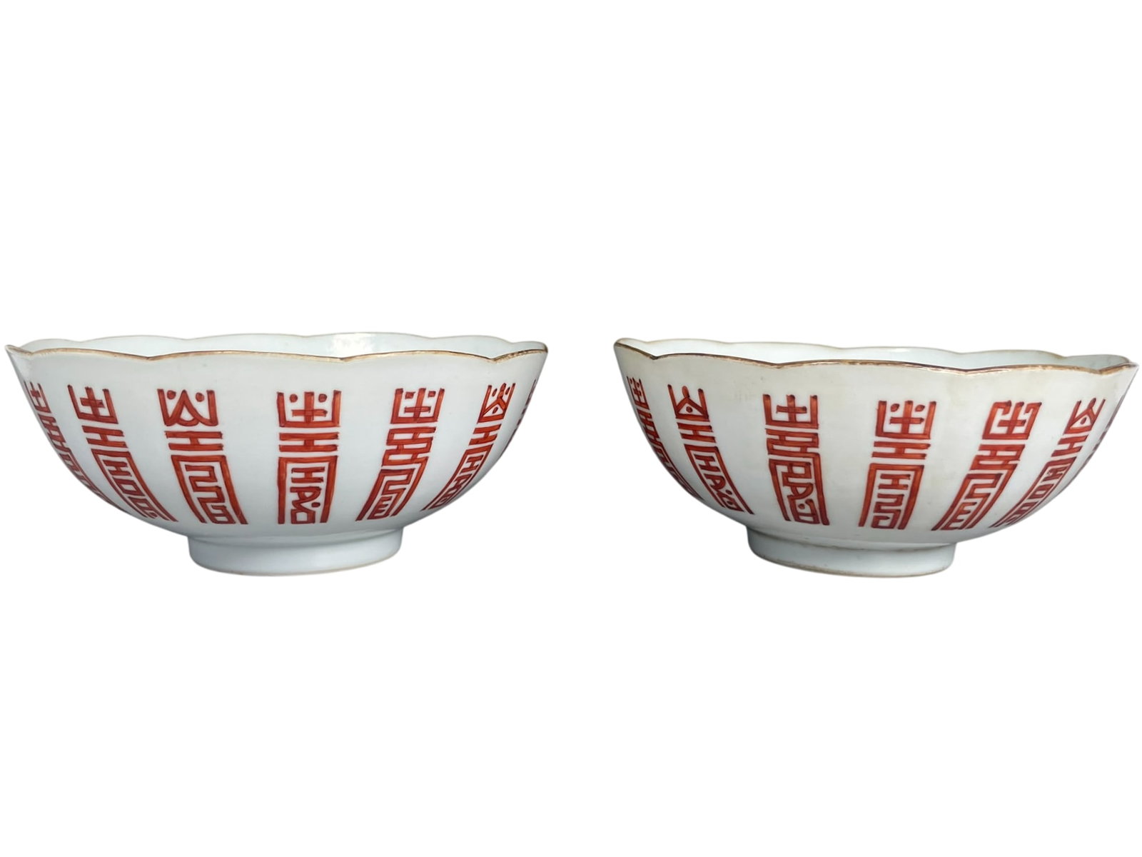 A Pair of Chinese Iron-Decorated 'Shou Character' Porcelain Bowls, Daoguang Period, Qing Dynasty: Apocryphal Daoguang mark to the underside of each. 2.3/8 in. high, 5.5/8 in. diam. each.