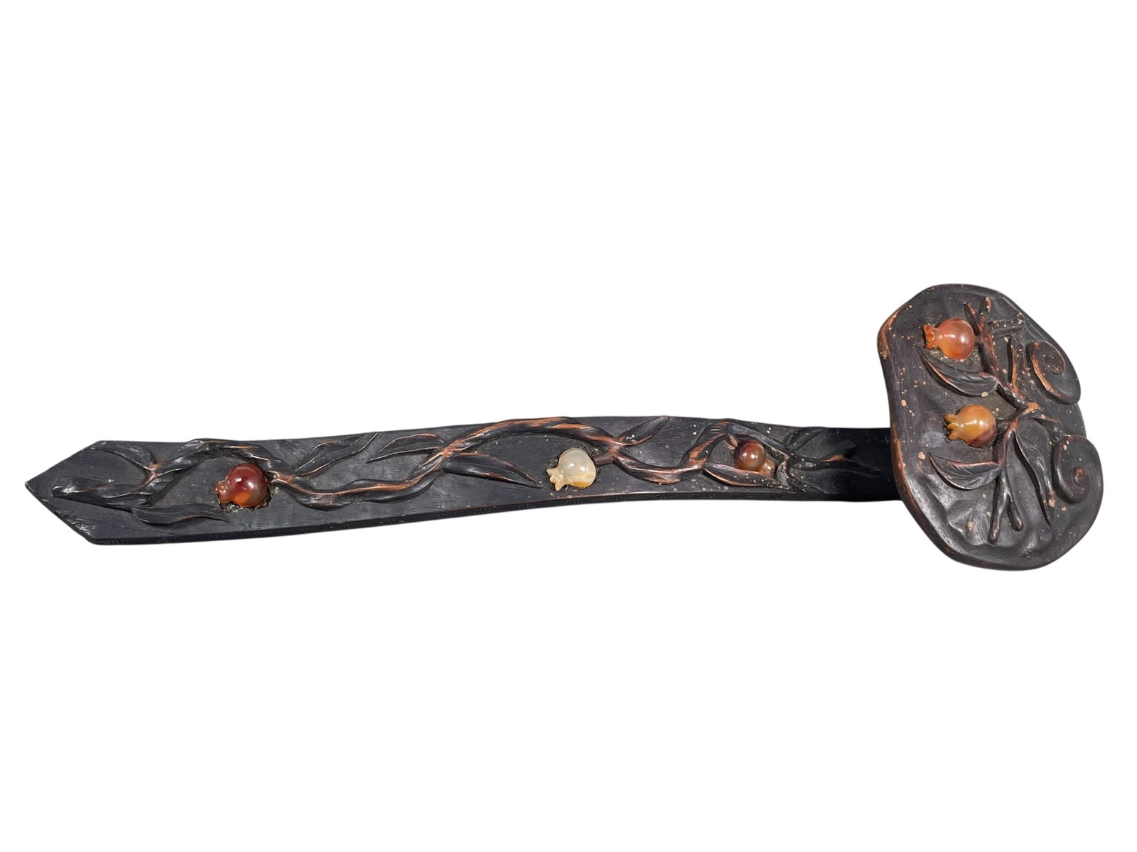 A Chinese Agate-Inset Carved Wood Ruyi Sceptre, Qing Dynasty: 14 in. long, 4 in. wide.