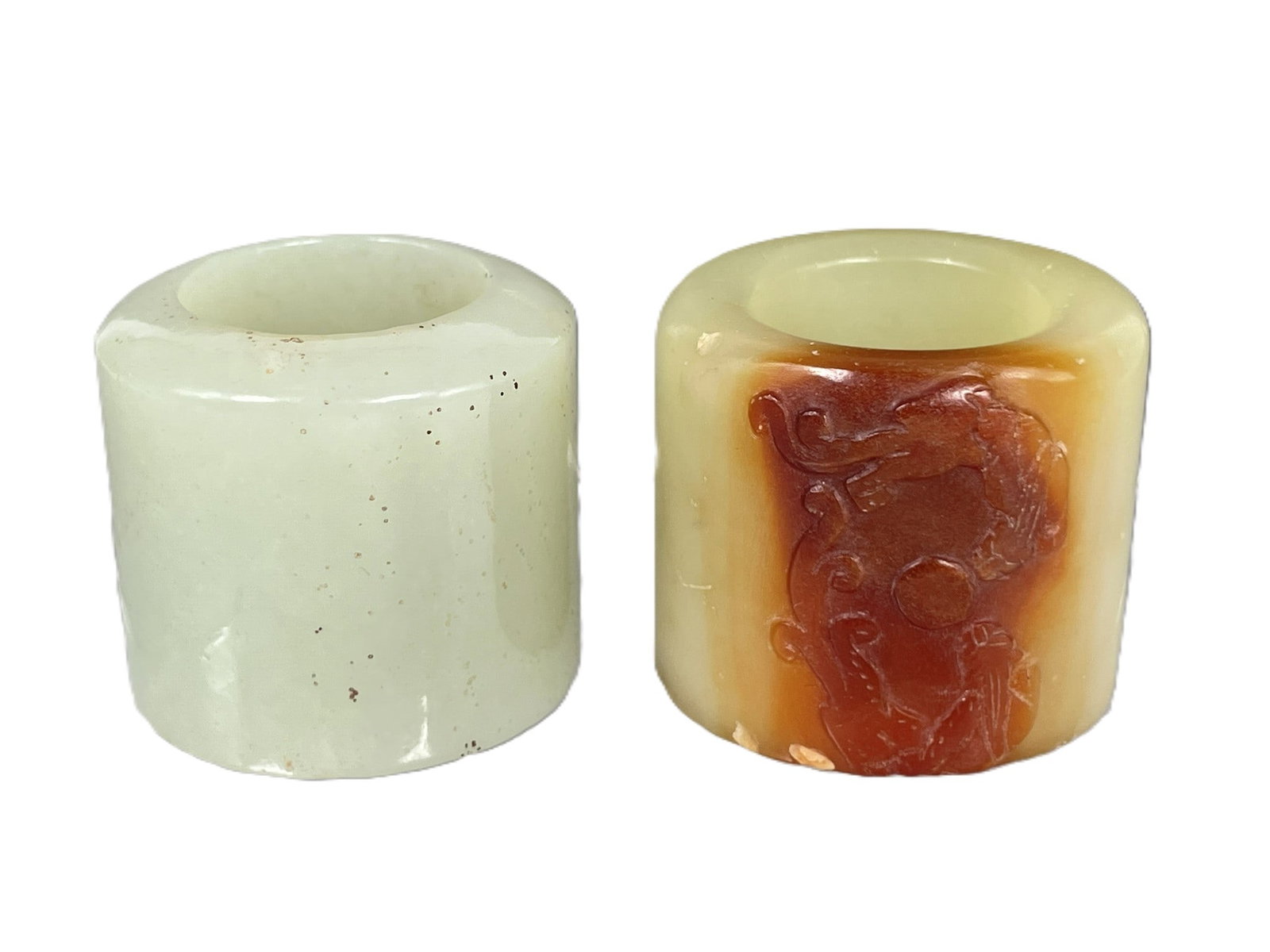 Two Chinese Jade Archer's Rings: 1.1/4 in. high, 1.3/8 in. diam. each.