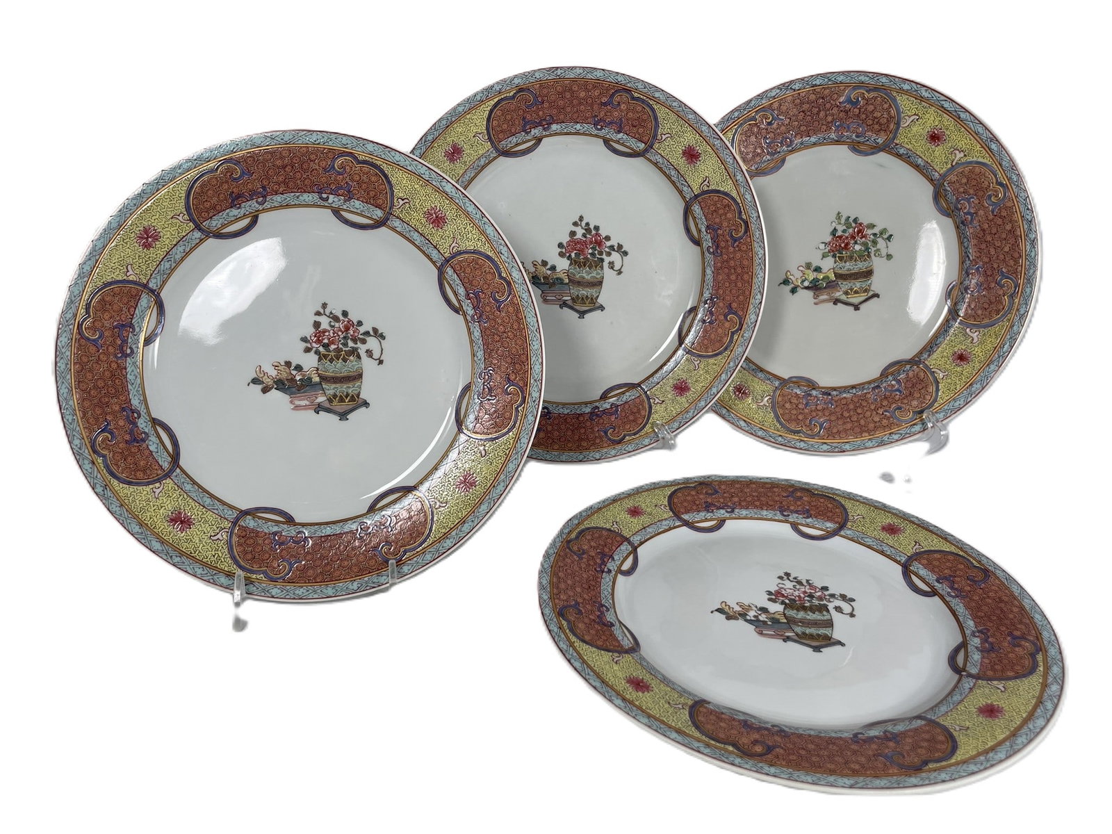 A Set of Four Chinese Export Famille Rose 'Flower Basket' Porcelain Dishes: 8.3/8 in. diam. each.
