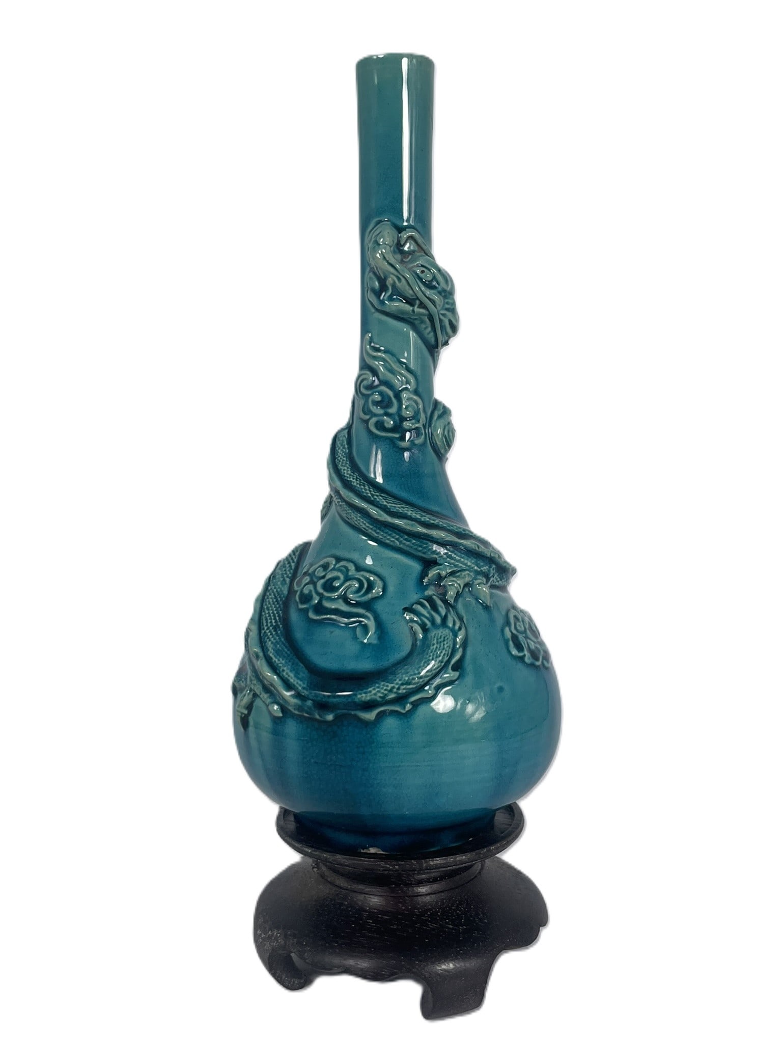 A Chinese Green-Glazed Molded 'Dragon' Vase: With a wood stand. The vase measures 9 in. high, 4 in. wide.