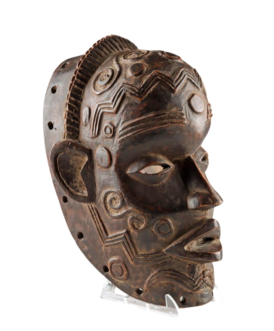 An African Lulua Wood Mask w/ Scarification, Pre-1945: Central Africa, Democratic Republic of the Congo, Lulua culture, circa pre-1945. A rare and finely carved wooden mask decorated with intricate raised geometric motifs inspired by the longstanding Lulu