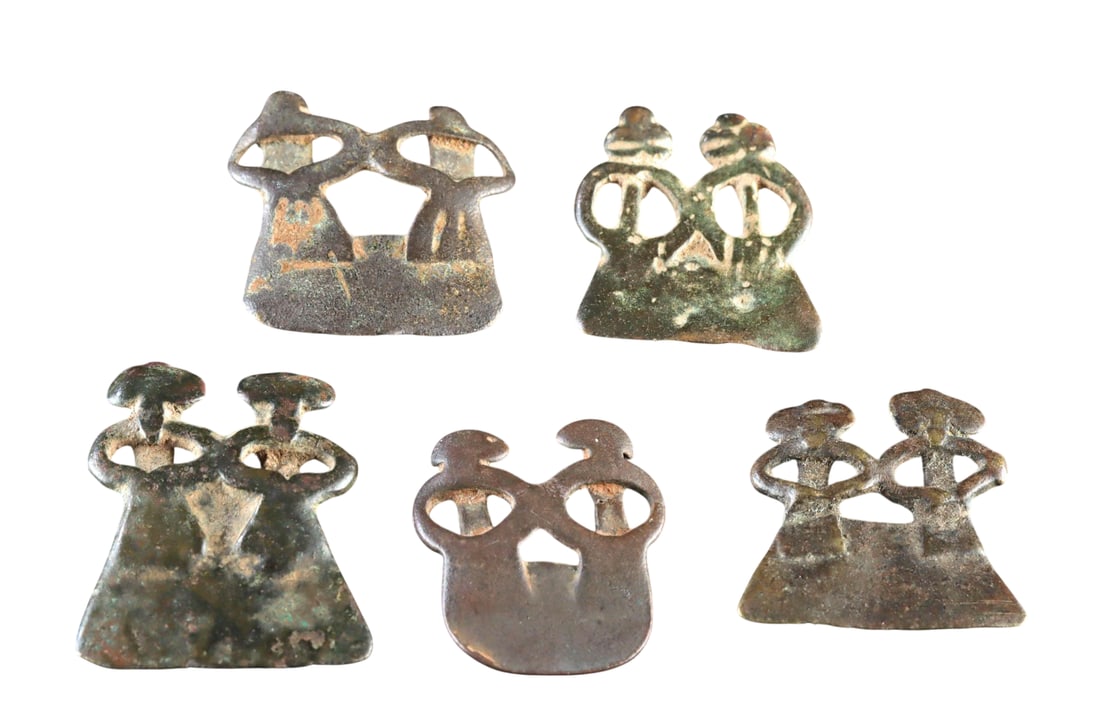 A Group of Five African Senufo Brass Divination/Ancestor Amulets, 19th to Early 20th Century: West Africa, Burkina Faso or Cote d?Ivoire, Senufo culture, circa 19th to early 20th century. A group of five conjoined pairs of stylized brass amulet figures, traditionally employed by Senufo diviner