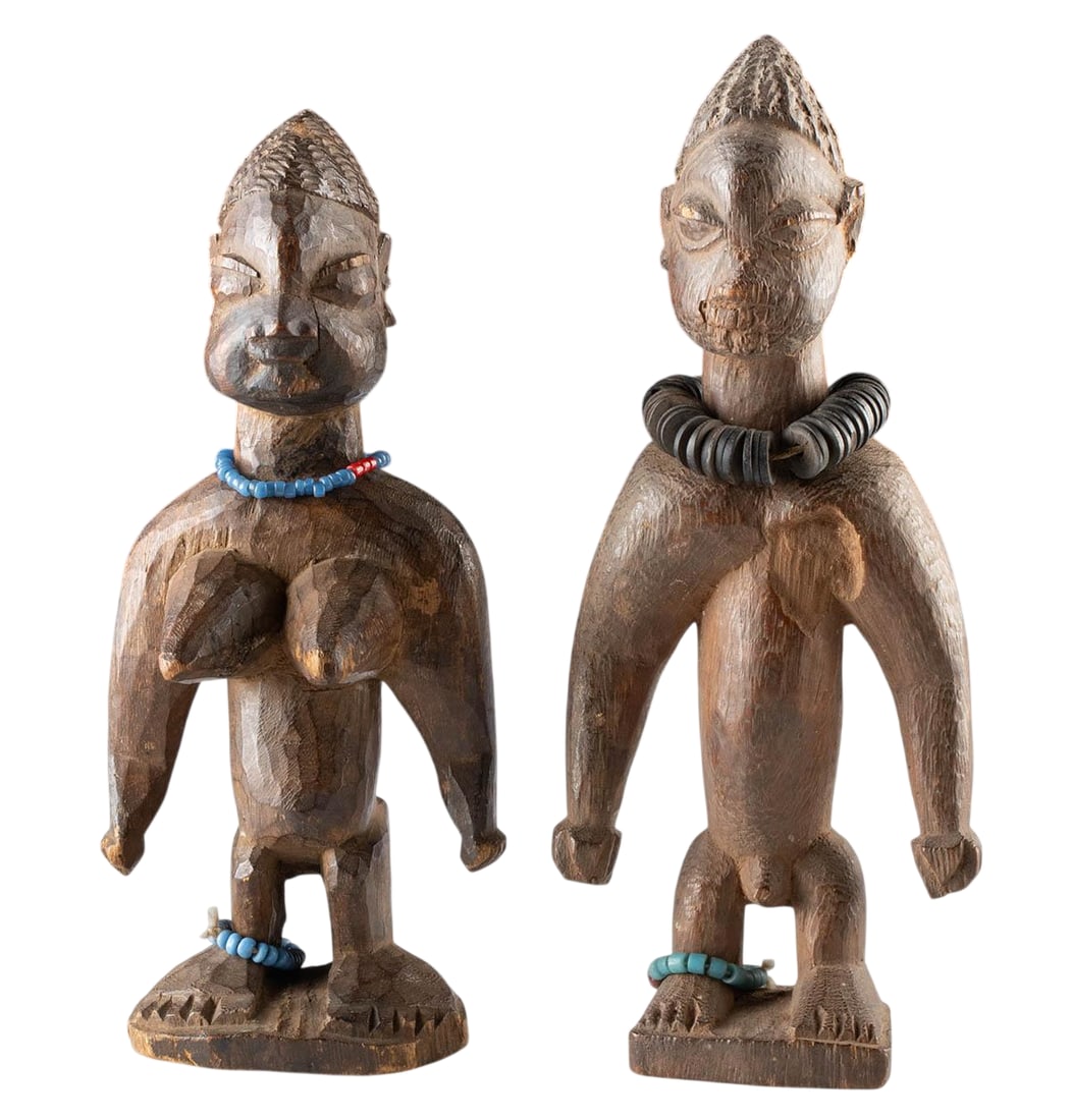 Early 20th C. African Yoruba Wooden Ere Ibeji Twins: West Africa, Nigeria, Yoruba peoples, early 20th century. A pair of hand-carved wooden Ere Ibeji figures representing a male and female twin, symbolic embodiments of twin spirits in Yoruba culture. Ea