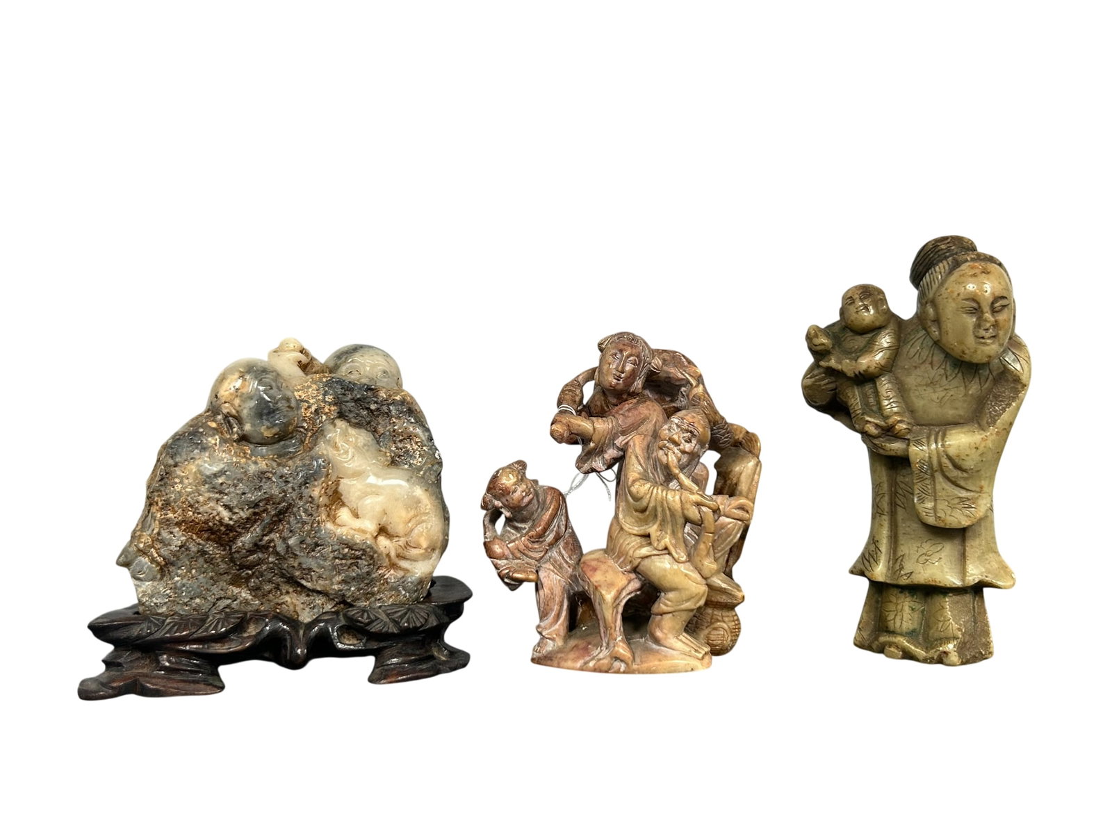 A Group of Three Shoushan Soapstone Carvings: The tallest lady and boy figure measures 4.3/4 in. high, 2.1/2 in. wide.