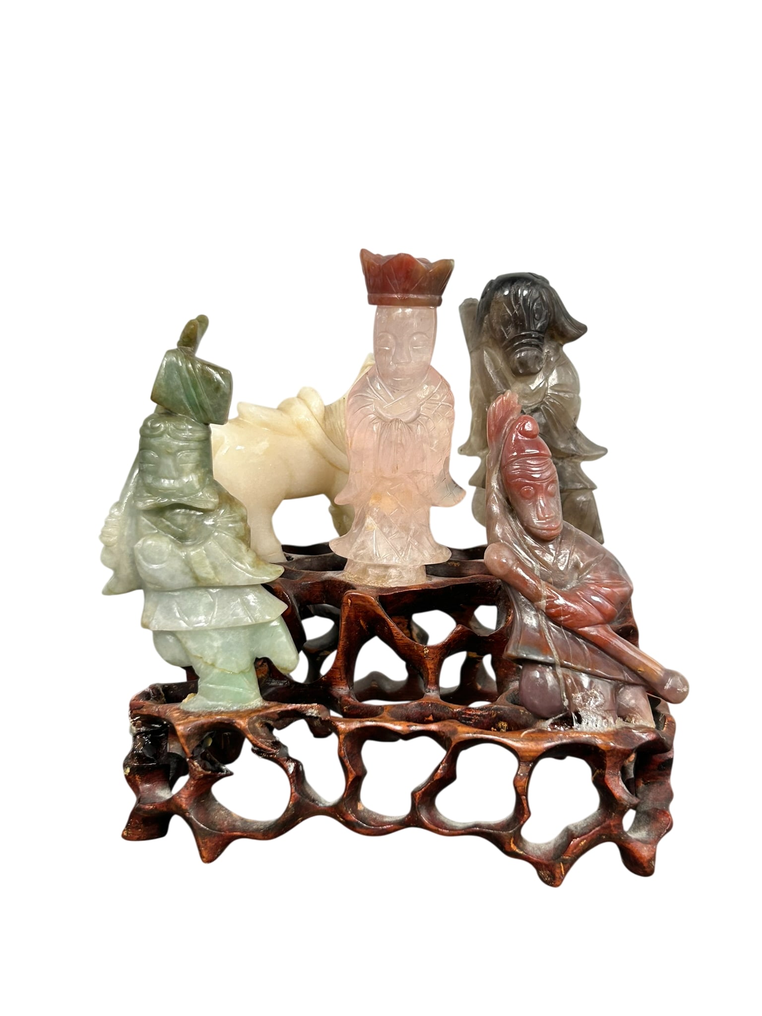 A Chinese Carved Jadeite and Agate Figural Group of the Tang Monk and His Disciples: All mounted on a reticulated wood stand, 4.3/4 in. high, 4.1/2 in. wide overall including the stand.