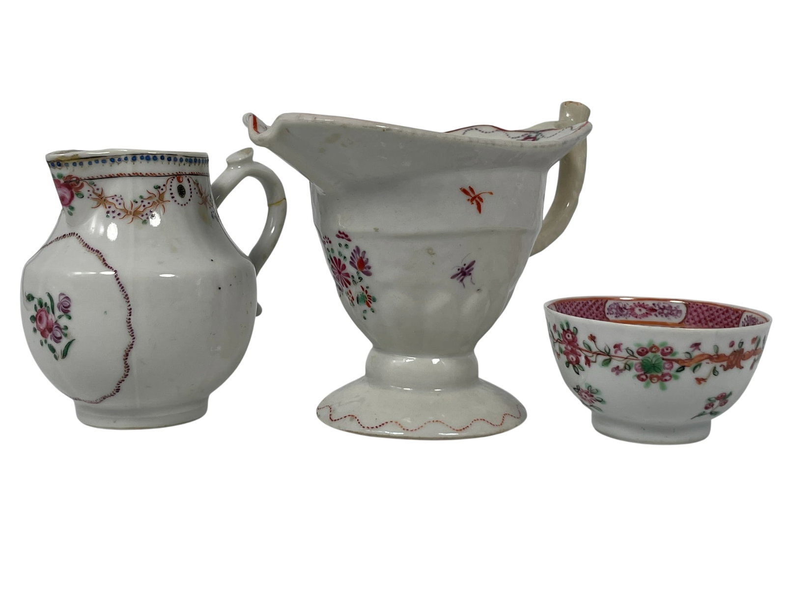 A Group of Three Chinese Export Famille Rose Porcelain Ware: Comprising a helmet jug, 4.3/4 in. high, 6.1/2 in. wide; a creamer, 4 in. high, 4.1/2 in. wide; and a small bowl, 1.3/4 in. high, 3 in. diam.