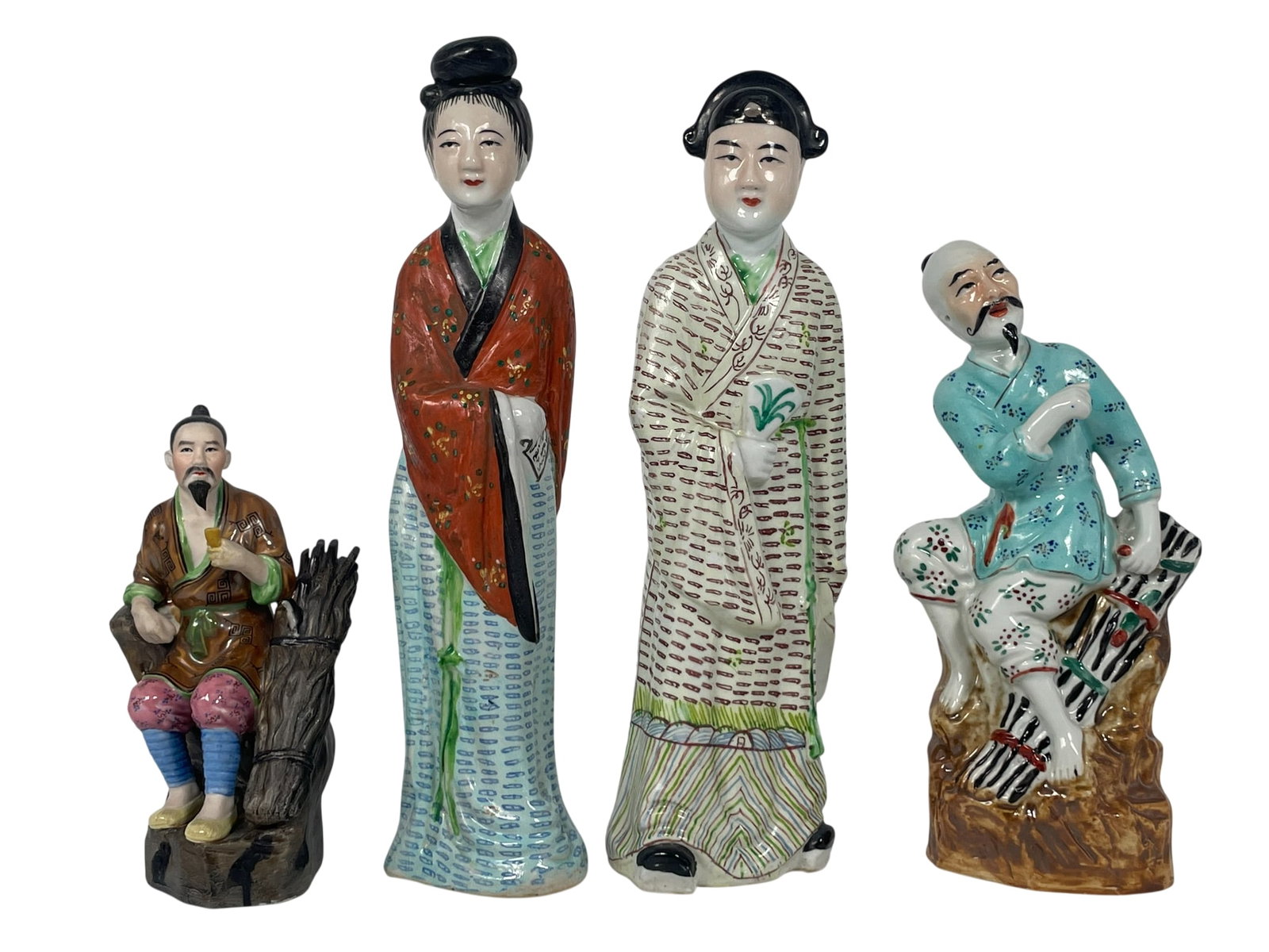 A Group of Four Chinese Famille Rose Porcelain Figures: The tallest measures 12 in. high, 3 in. wide.