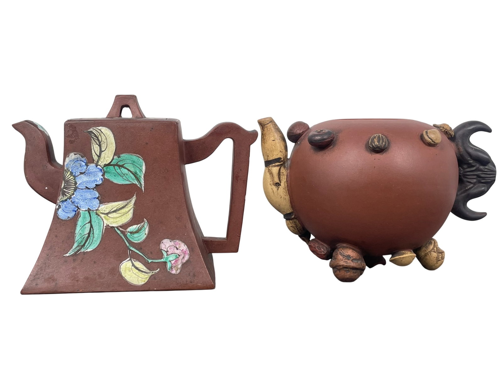 Two Chinese Yixing Pottery Teapots and One Cover: Comprising a teapot and cover, 4.1/2 in. high, 6 in. wide; and a teapot without cover, 4 in. high, 6.1/4 in. wide.