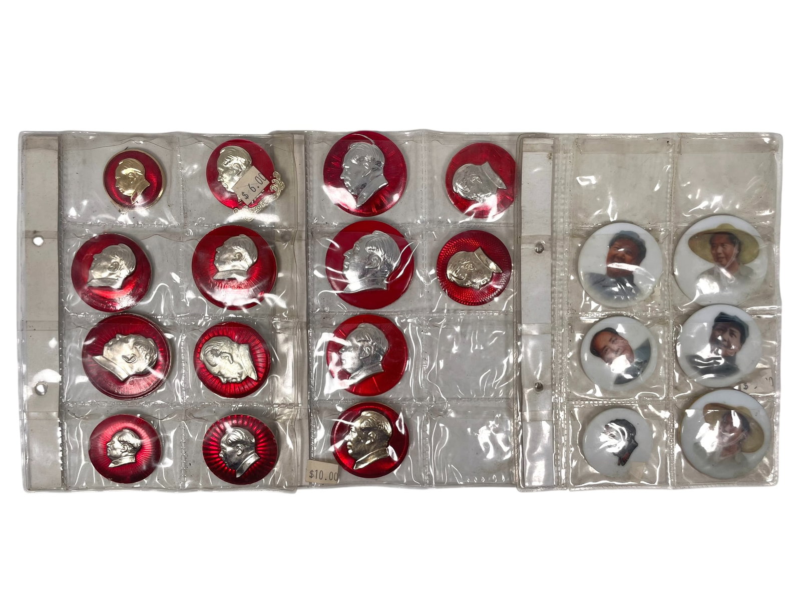 A Group of Twenty Chairman Mao badges: Comprising six porcelain badges manufactured in Jingdezhen, and fourteen metal badges. The largest measures 2 in. diam.