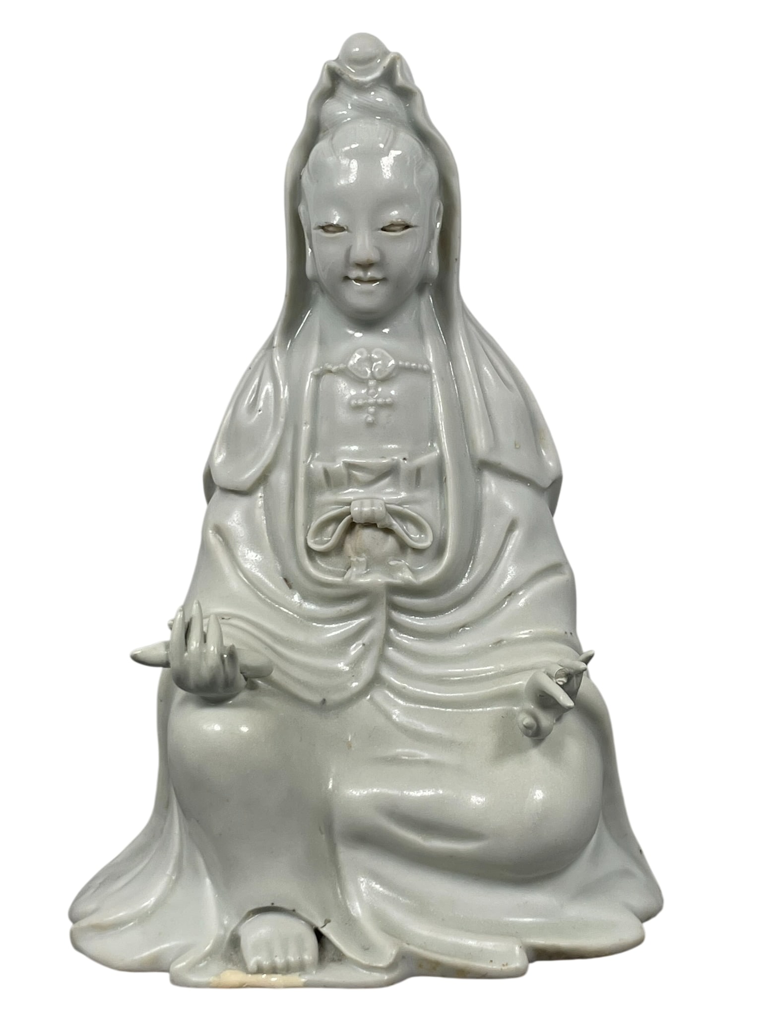 A Chinese Dehua-Style Porcelain Figure of Seated Guanyin: 7.3/4 in. high, 5.1/4 in. wide.