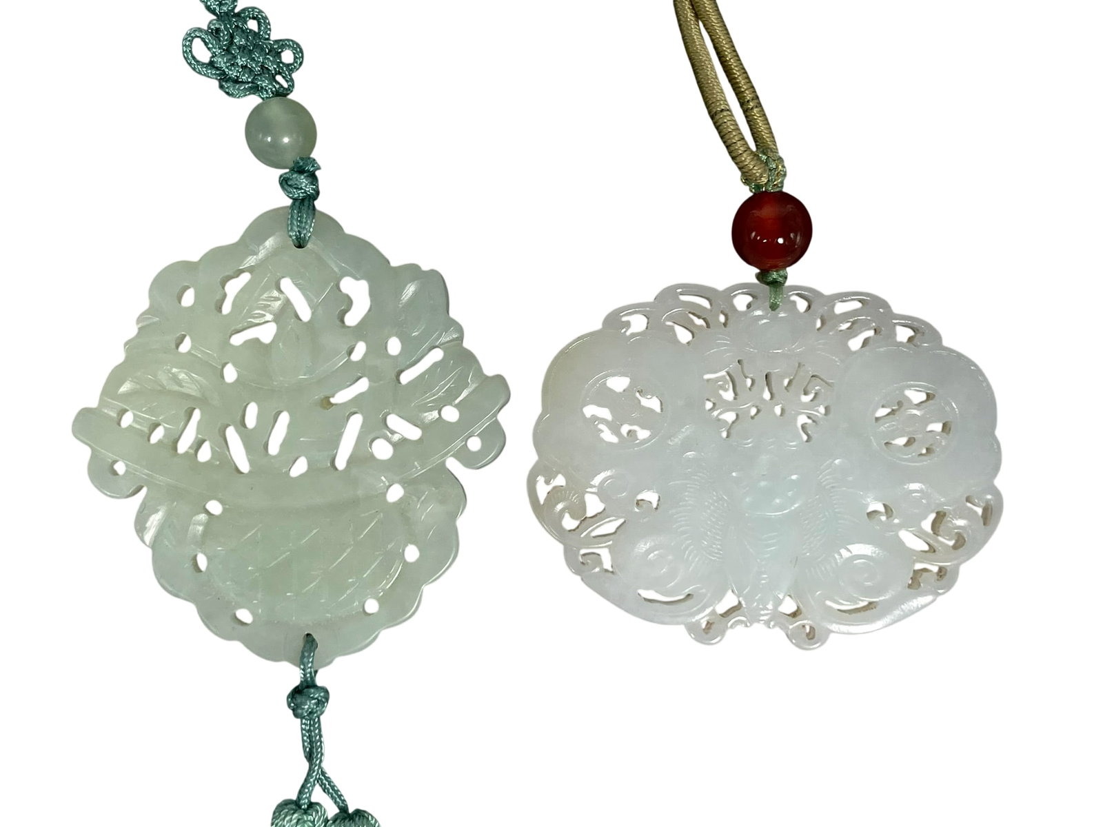 Two Chinese Carved Jade Plaques: The white one measures 2.3/8 in. long, 1.7/8 in. wide; the other measures 2.1/8 in. long, 2.18 in. wide.