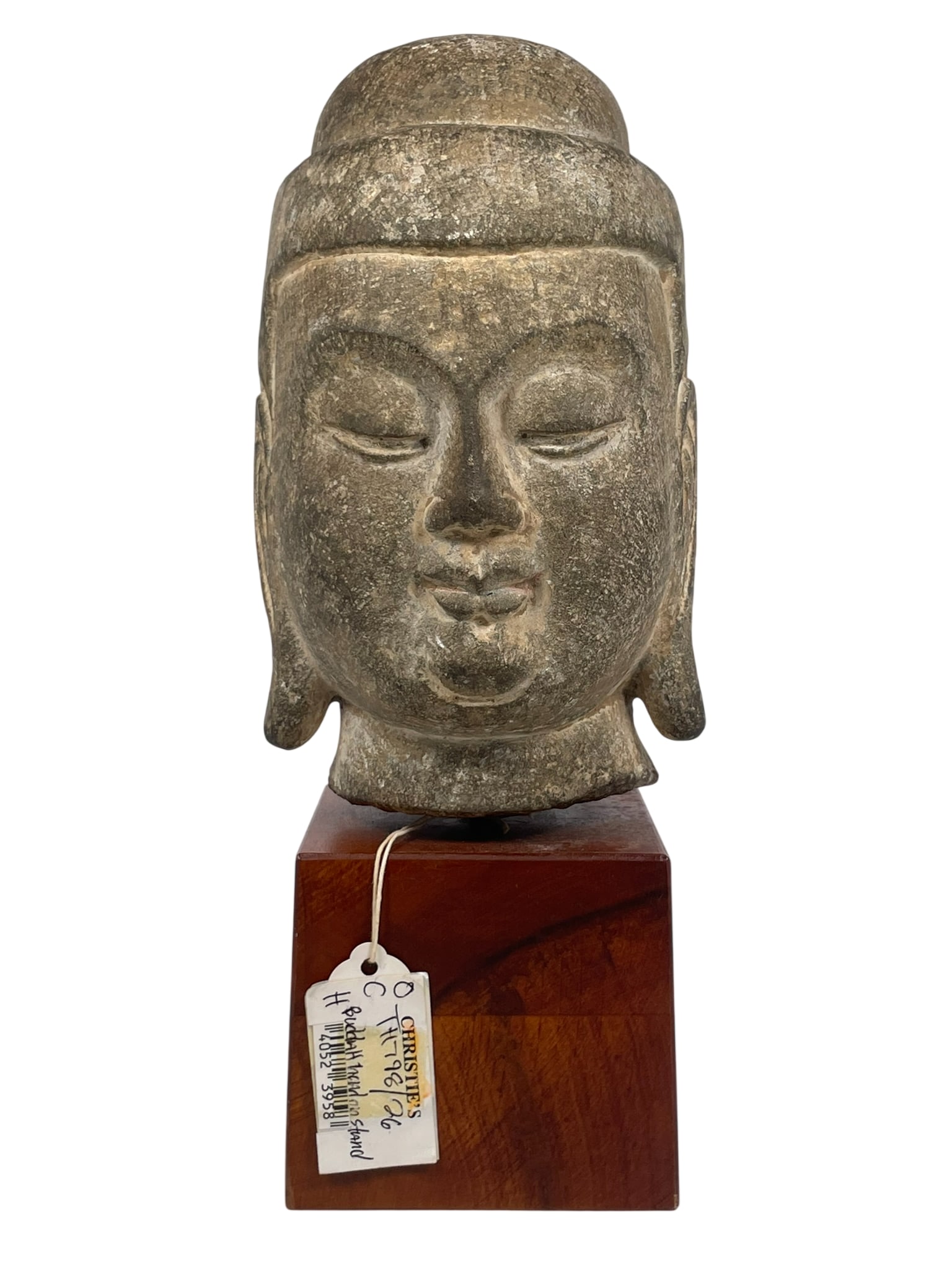 A Chinese Carved Sandstone Head of Buddha: With a Christie's tag. 8.1/2 in. high, 5 in. wide for the head; 12.1/2 in. high, 5 in. wide overall including the base.