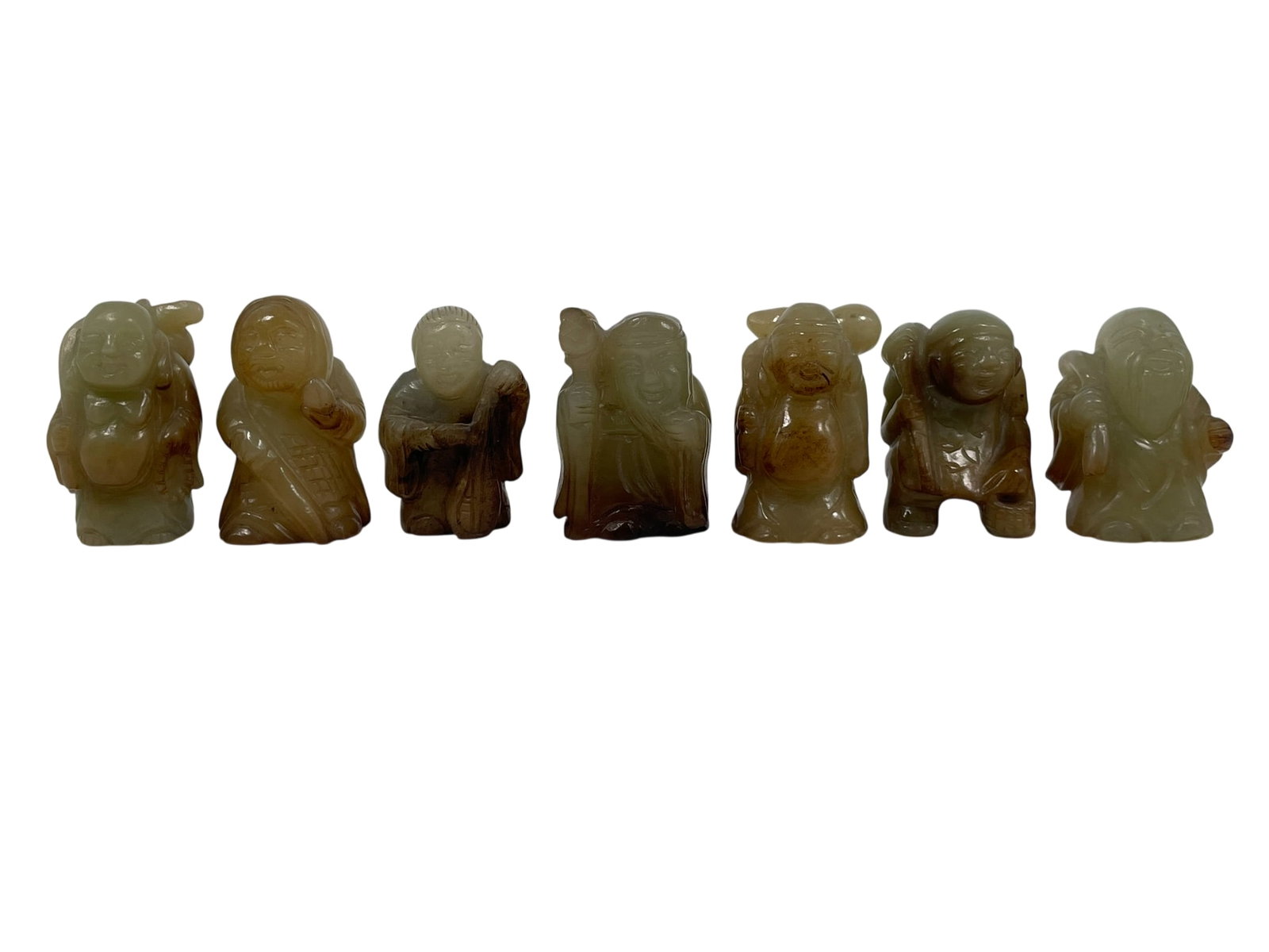 A Group of Seven Chinese Carved Jade Figures: Each measures around 2.1/8 in. high, 1.1/4 in. wide.