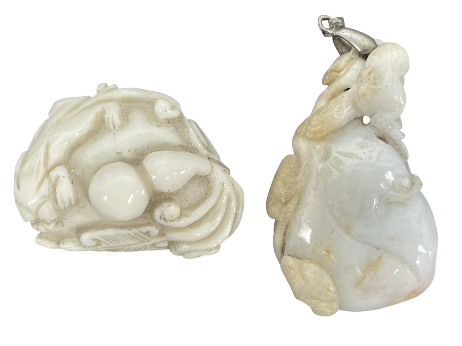 Two Chinese Stone Carvings: Comprising a pendant, 2.3/8 in. high, 1.1/2 in. wide; and the other carving measures 1.7/8 in. long, 1.3/8 in. wide.