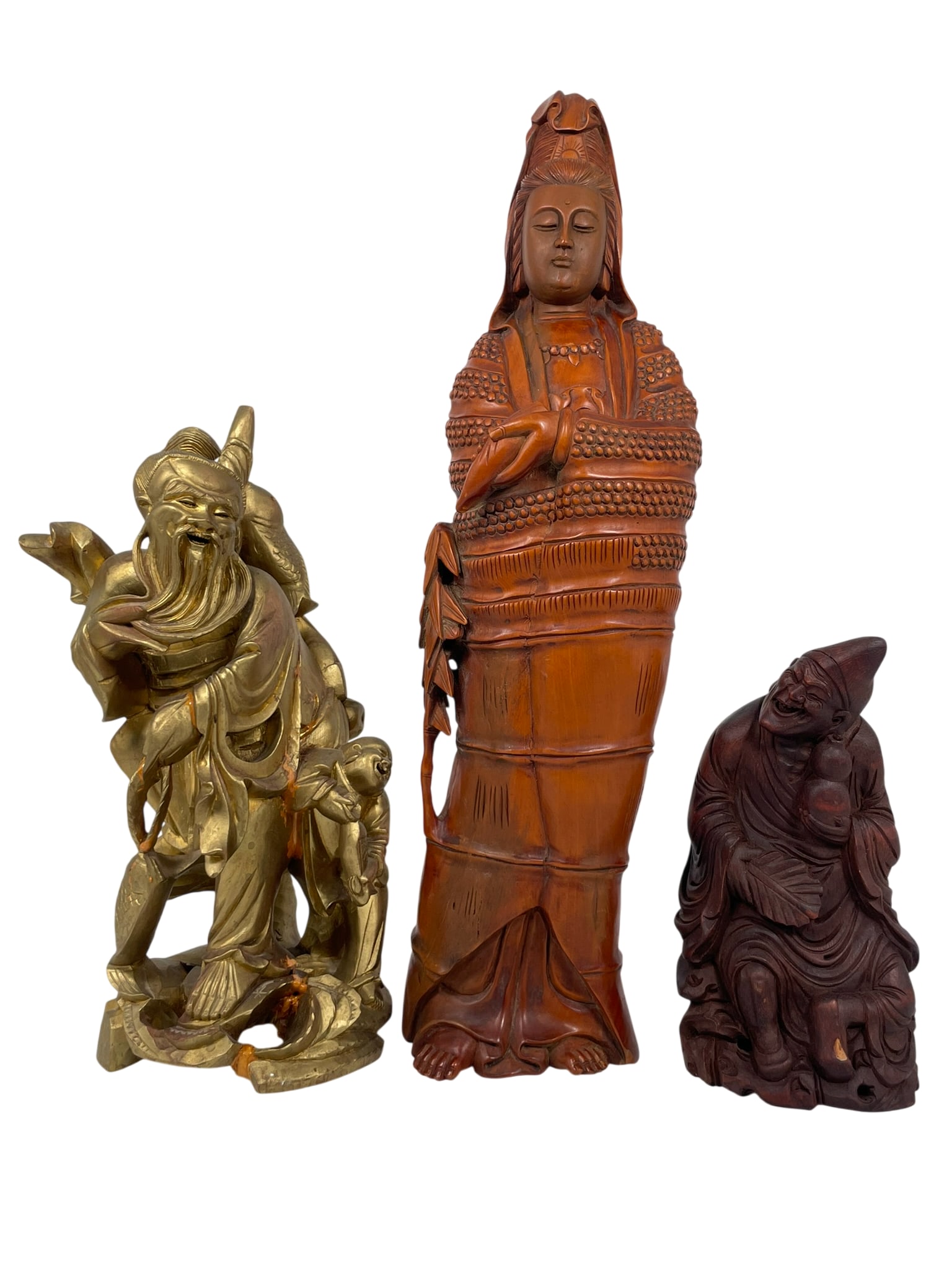 A Group of Three Carved Wood Figures: Comprising a standing guanyin, 18.1/2 in. high, 5 in. wide; a figure of fisherman and boy, 12.1/2 in. high, 6.1/2 in. wide; and a figure of Ji Gong, 8.1/4 in. high, 4.1/4 in. wide.