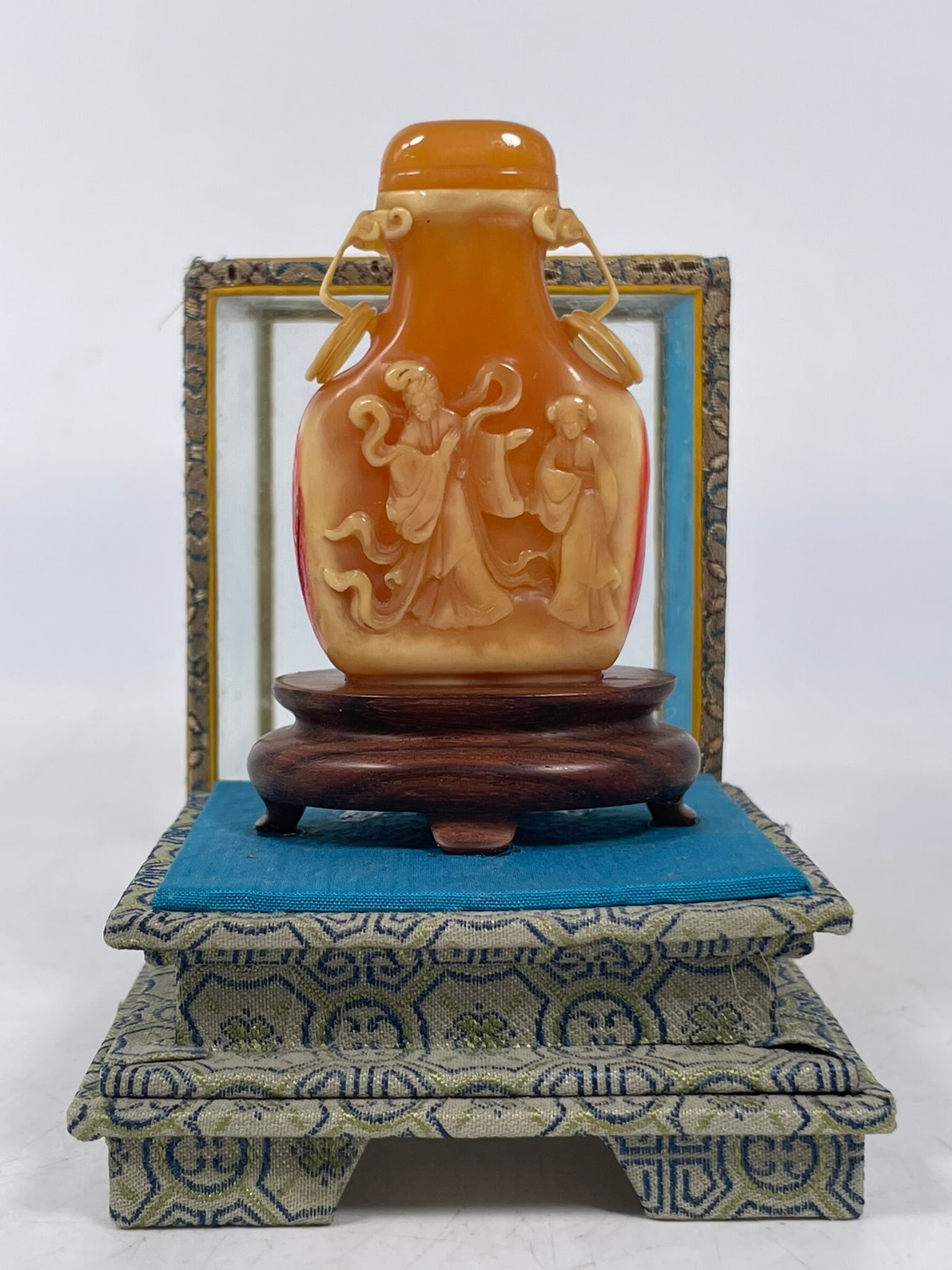A Chinese Carved Bone Snuff Bottle, Qianlong Mark: With a covering box, the snuff bottle measures 2.1/2 in. high, 1.1/2 in. wide for the snuff bottle, 5.1/4 in. high, 3 in. square overall including the case.