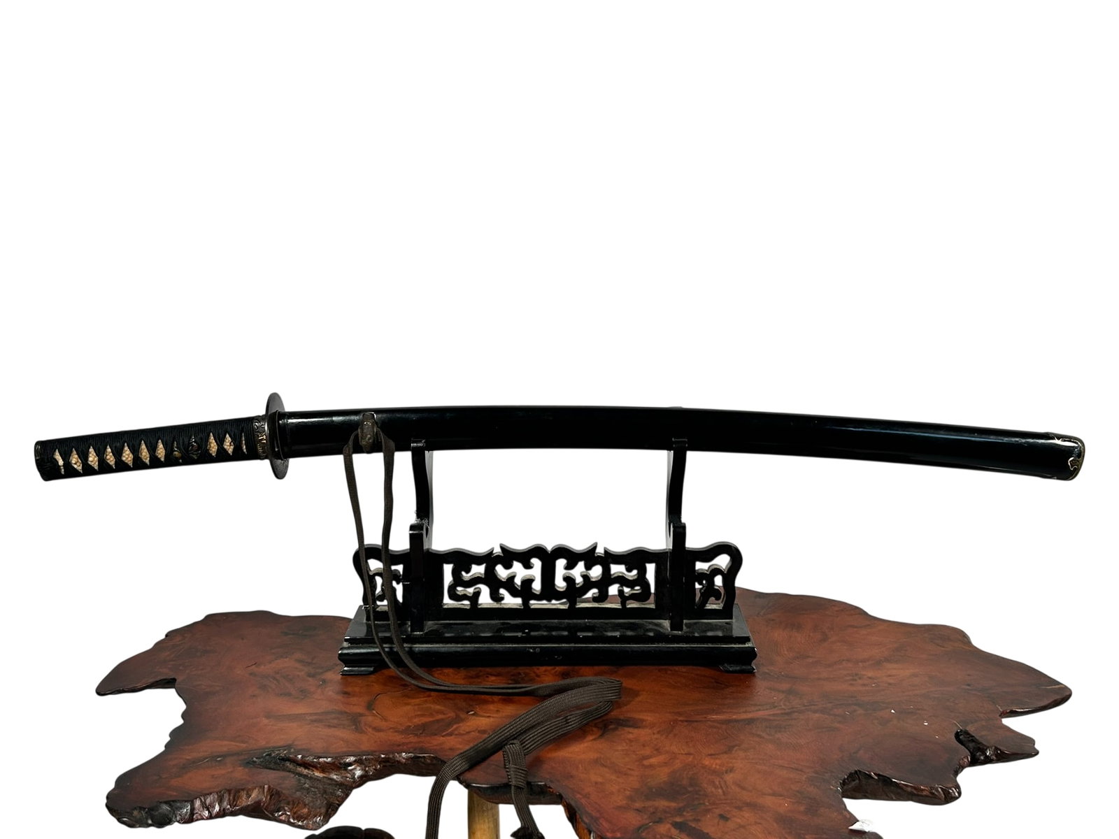 A Japanese Wood Sword: Not an actual sword but a bokken, with sword fittings,saya and tsuka.23 in. long for the wood cutting edge, 33.1/2 in. long overall.