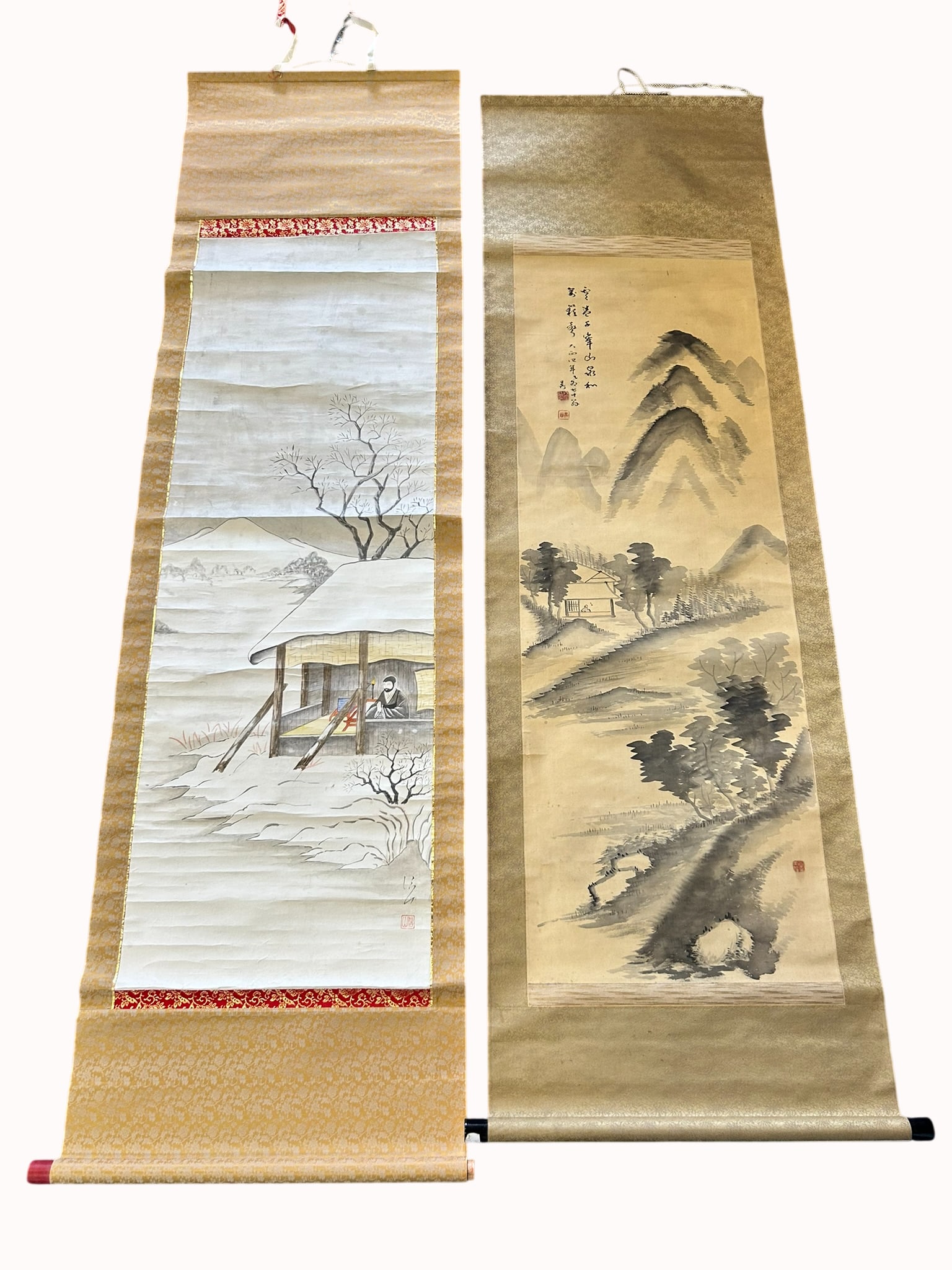 Two Japanese Paintings of Landscape: Comprising a painting of landscape with a figure in a hut, a signature of the artist and a seal, 70 in. x 20.1/2 in. overall; and a painting of landscape, a signature Ishikawa Gozan and three seals,