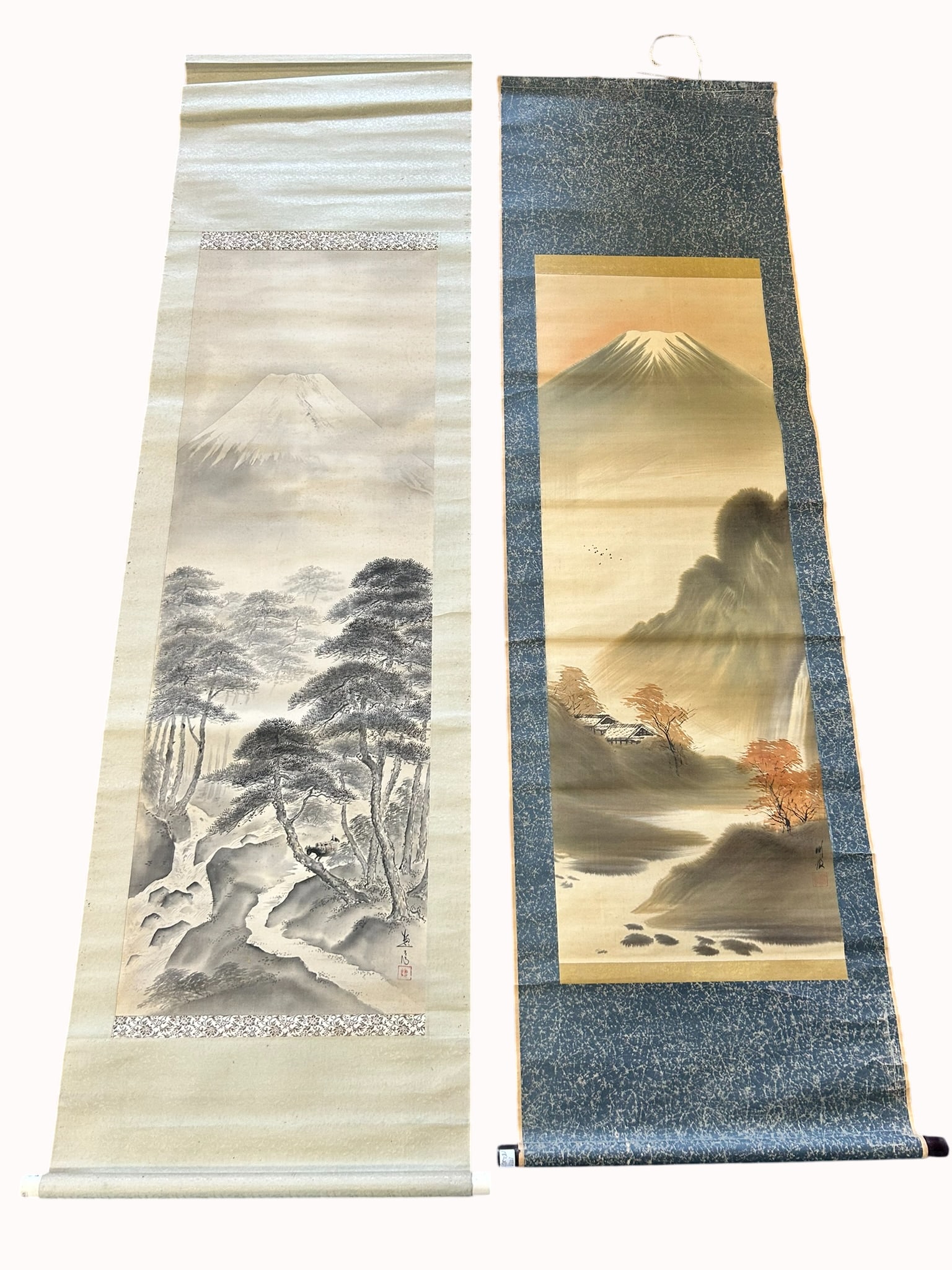 Two Japanese Paintings of Mount Fuji: Comprising a painting of Mount Fuji and forest, a signature of the artist and a seal, 75 in. x 21.1/2 in. overall; 72 in. x 21 in. overall.