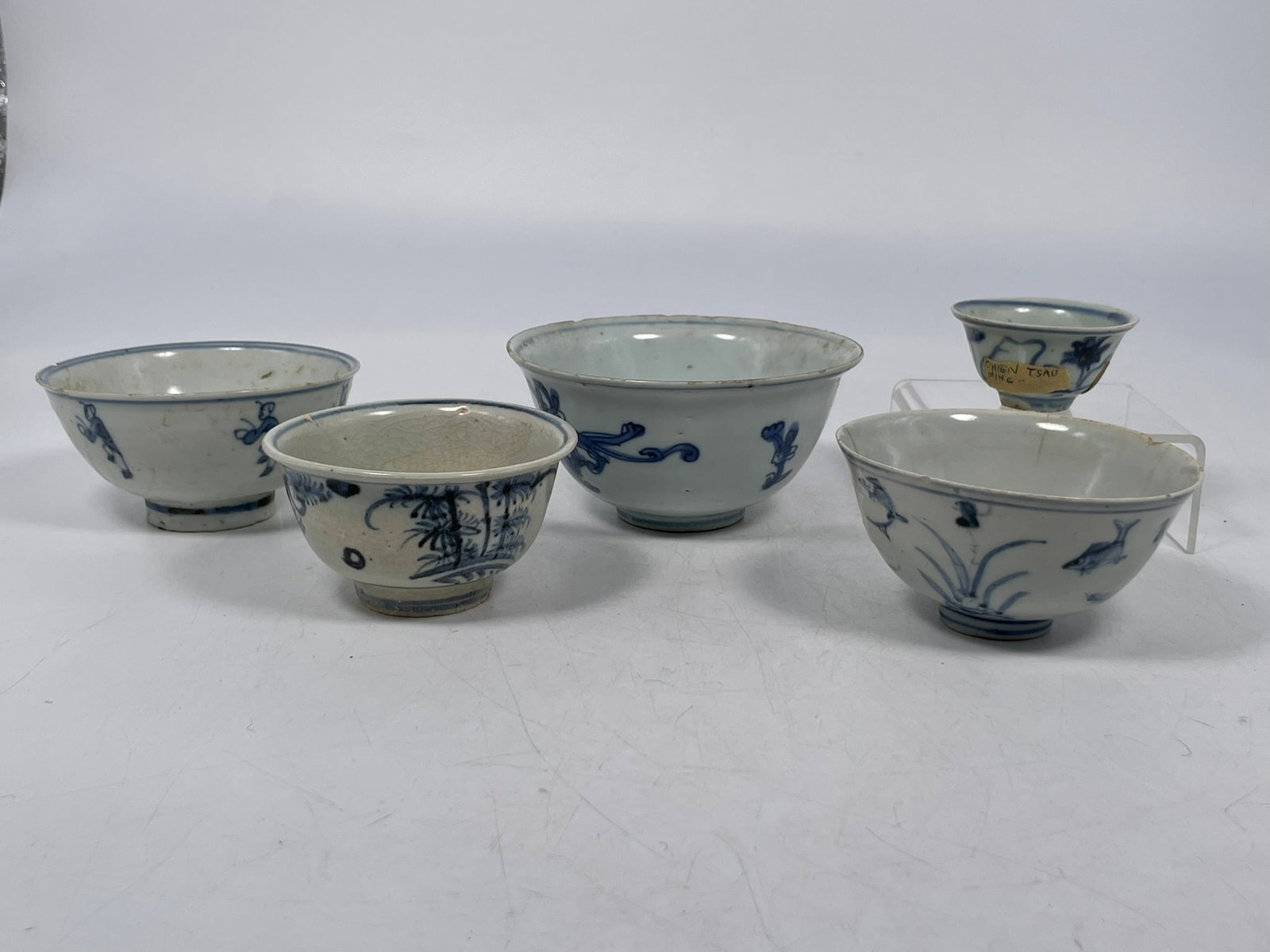 A Group of Five Chinese Blue and White Ware, Ming Dynasty: Comprising four bowls, with the largest measures 2.3/8 in. high, 4.7/8 in. diam.; and a small cup, 1.1/4 in. high, 2.1/2 in. diam. Provenance: From the renowned John Allen Tabor Collection. John Tabor