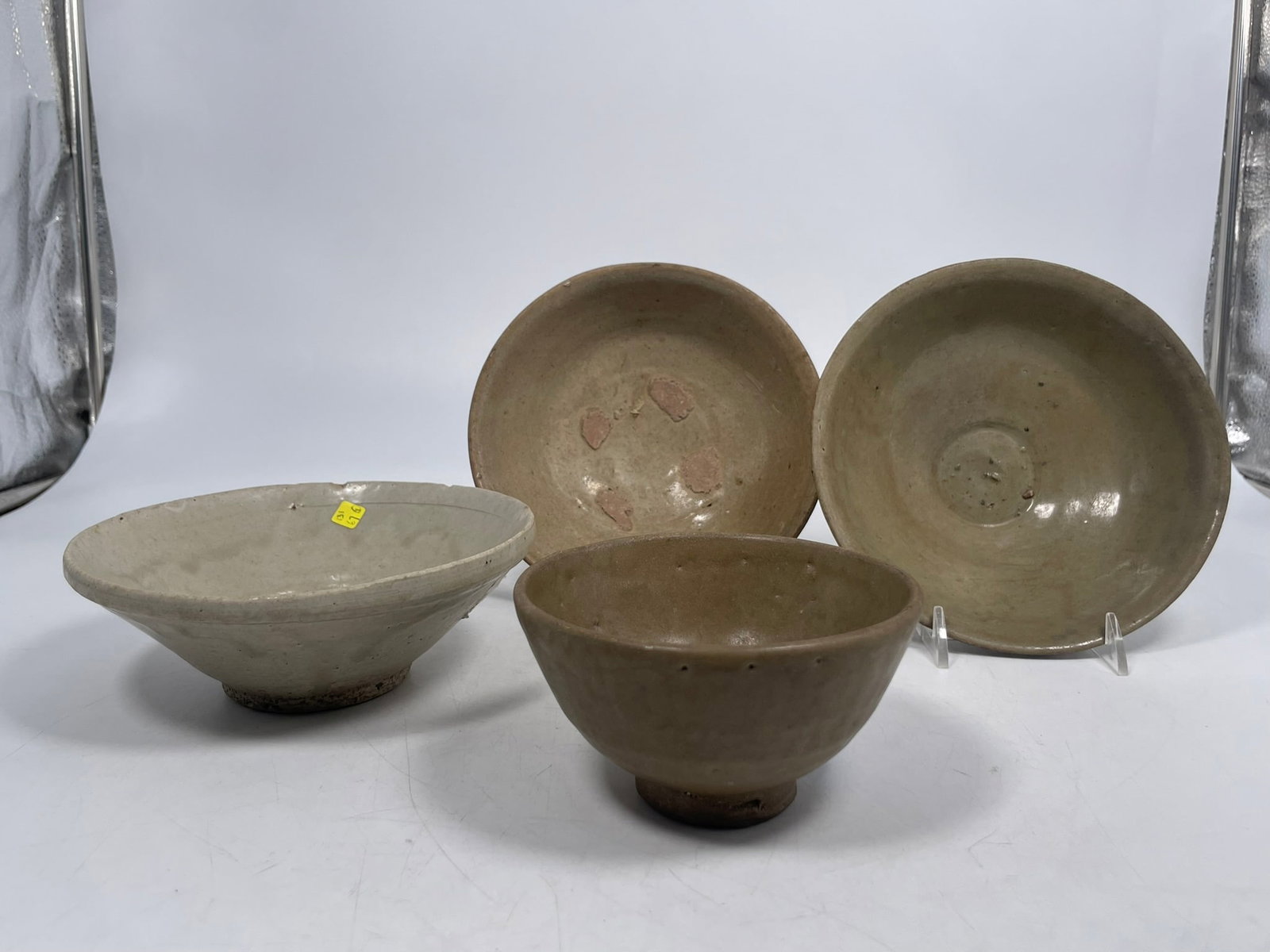 A Group of Four Celadon-Glazed Porcelain Bowls: The largest measures 2.1/2 in. high, 6.3/8 in. diam. Provenance: From the renowned John Allen Tabor Collection. John Tabor (1917?1991), a U.S. Foreign Service officer with USAID, worked throughout