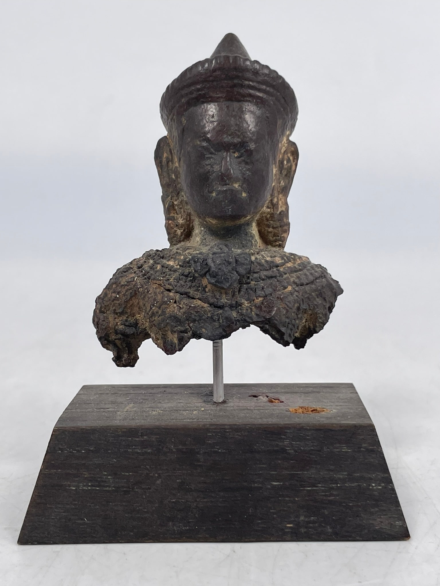A Khmer-Style Bronze Bust of Lakshmi: Mounted on a wood stand, the bronze bust measures 2.1/2 in. high, 2 in. wide. A Private Collection of a Retiring University Professor.