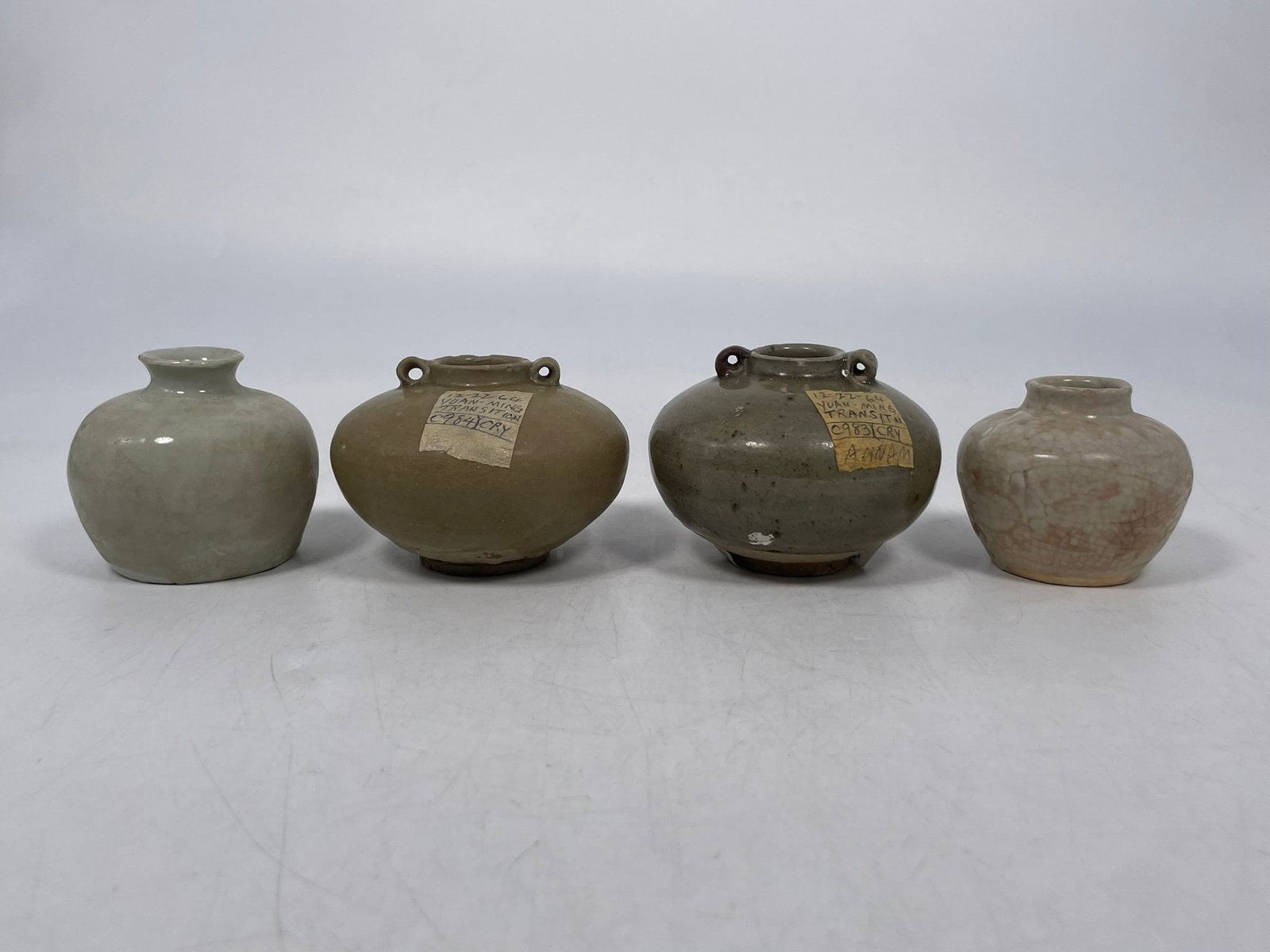 A Group of Three Chinese Small Celadon-Glazed Jars, Yuan/Ming Dynasty: The largest measures 2.1/2 in. high, 3.1/2 in. diam. Provenance: From the renowned John Allen Tabor Collection. John Tabor (1917?1991), a U.S. Foreign Service officer with USAID, worked throughout