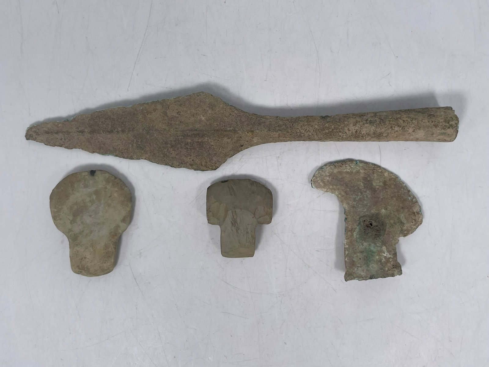 A Group of Four Bronze/Stone Weapons: The largest measures 12 in. long, 2.1/4 in. wide. A Private Collection of a Retiring University Professor.