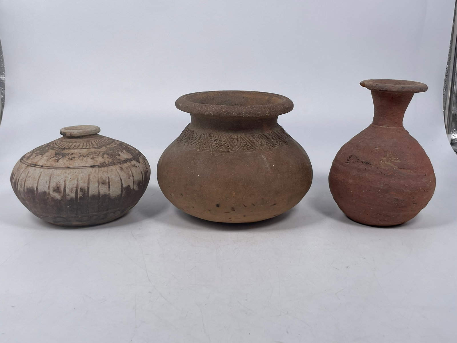 A Group of Three Pottery Jars: The largest one measures 5.1/4 in. high, 7 in. wide. A Private Collection of a Retiring University Professor.