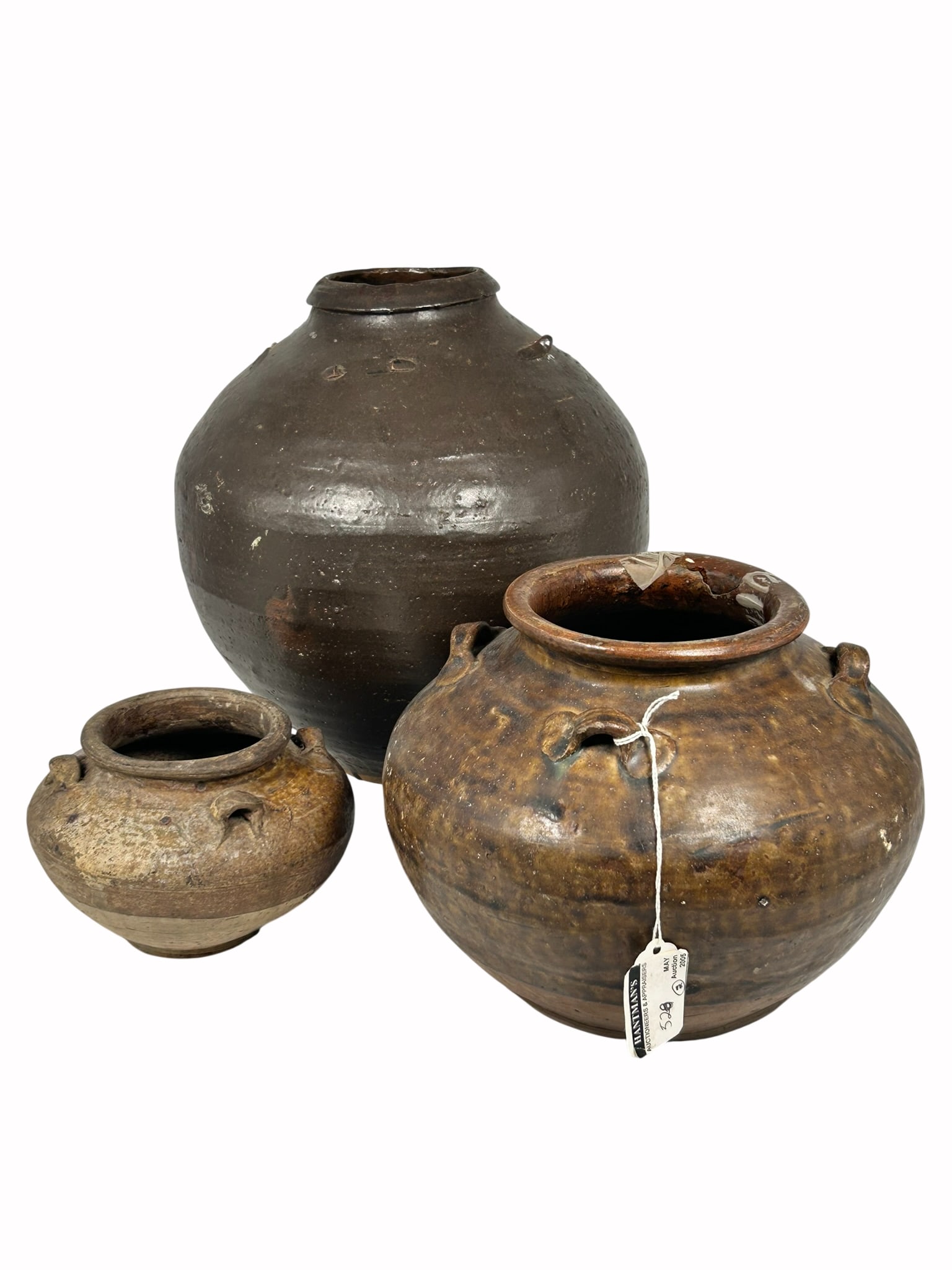 A Group of Three Chinese Brown-Glazed Jars, Ming Dynasty: The largest measures 10.1/2 in. high, 9.1/2 in. wide. Provenance: From the renowned John Allen Tabor Collection. John Tabor (1917?1991), a U.S. Foreign Service officer with USAID, worked throughout As
