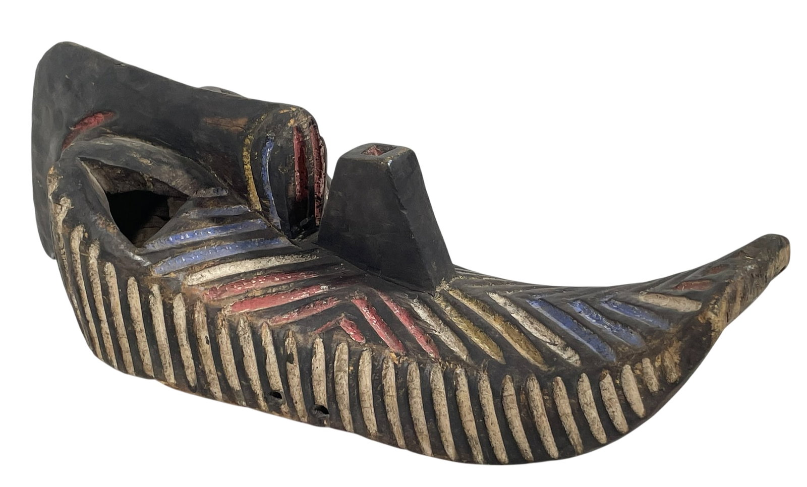 A Long Songye Kifwebe Mask, Congo Central Africa: Features geometric striations painted in red, white, and yellow. 27 in. high, 9 in. wide, 9 in. deep.