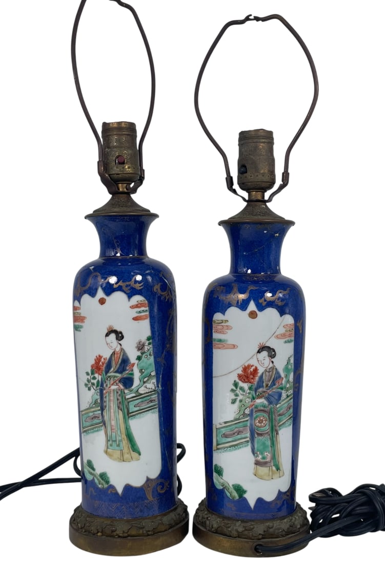 A Pair of Chinese Gilt-Decorated Blue-Ground Famille Rose 'Medallion' 'Ladies' Porcelain Vases,: Both mounted as lamps. The vases measures 10 in. high, 3.3/4 in. wide each, 18.1/2 in. high, 4.5/8 in. wide each overall.